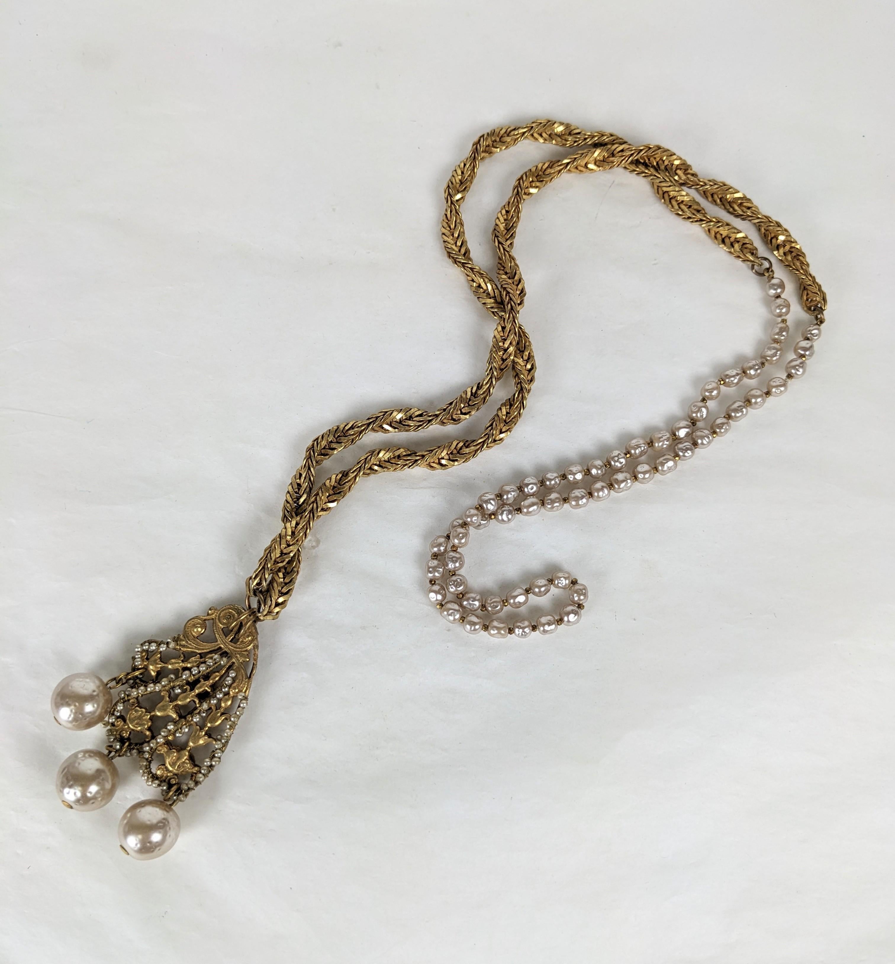 Miriam Haskell signature baroque pearl and Russian gold plate long pendant necklace. Chain of small baroque pearls with minute gold plated cut steel beads and gold plated twisted herringbone chain. The pendant has Art Nouveau back to back signature