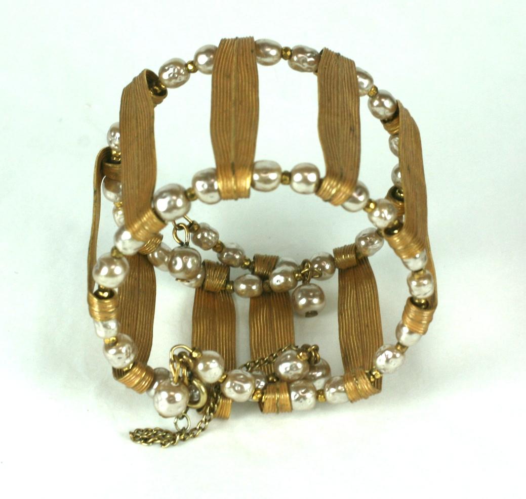 Miriam Haskell Russian Gilt and signature faux baroque pearl flexible cuff bracelet. Constructed of folded gilt  Iris leaves, faux baroque pearls, and small faceted gold plated cut steel beads.
Saftey chain at opening. Can fit all wrist