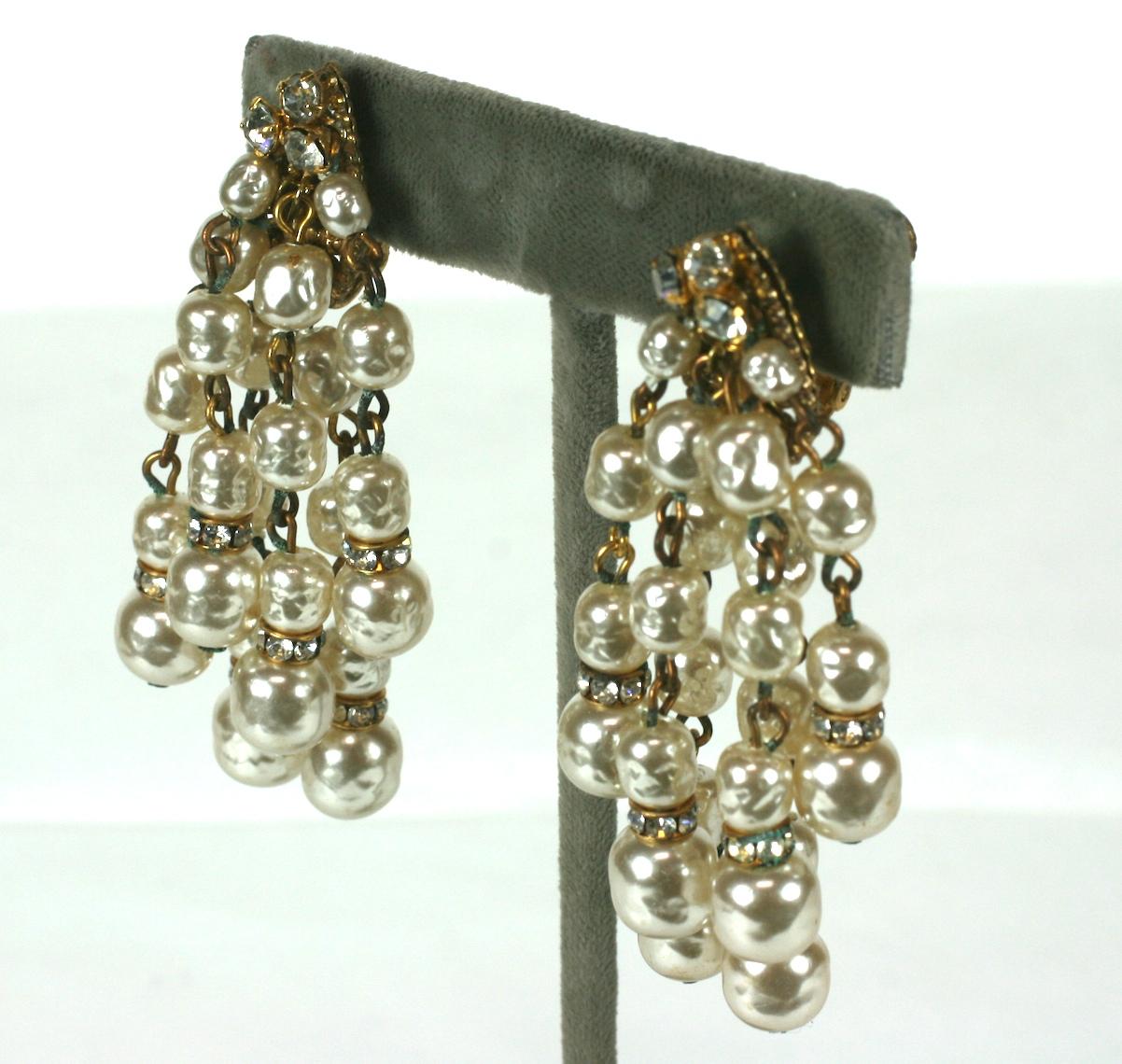Miriam Haskell signature baroque faux pearl and Russian Gold plate waterfall ear clips. The linked pearls of various sizes are spaced by crystal and gilt rondels.  Set on a filigree base with prong set crystal rhinestone points.  
Signed MIriam