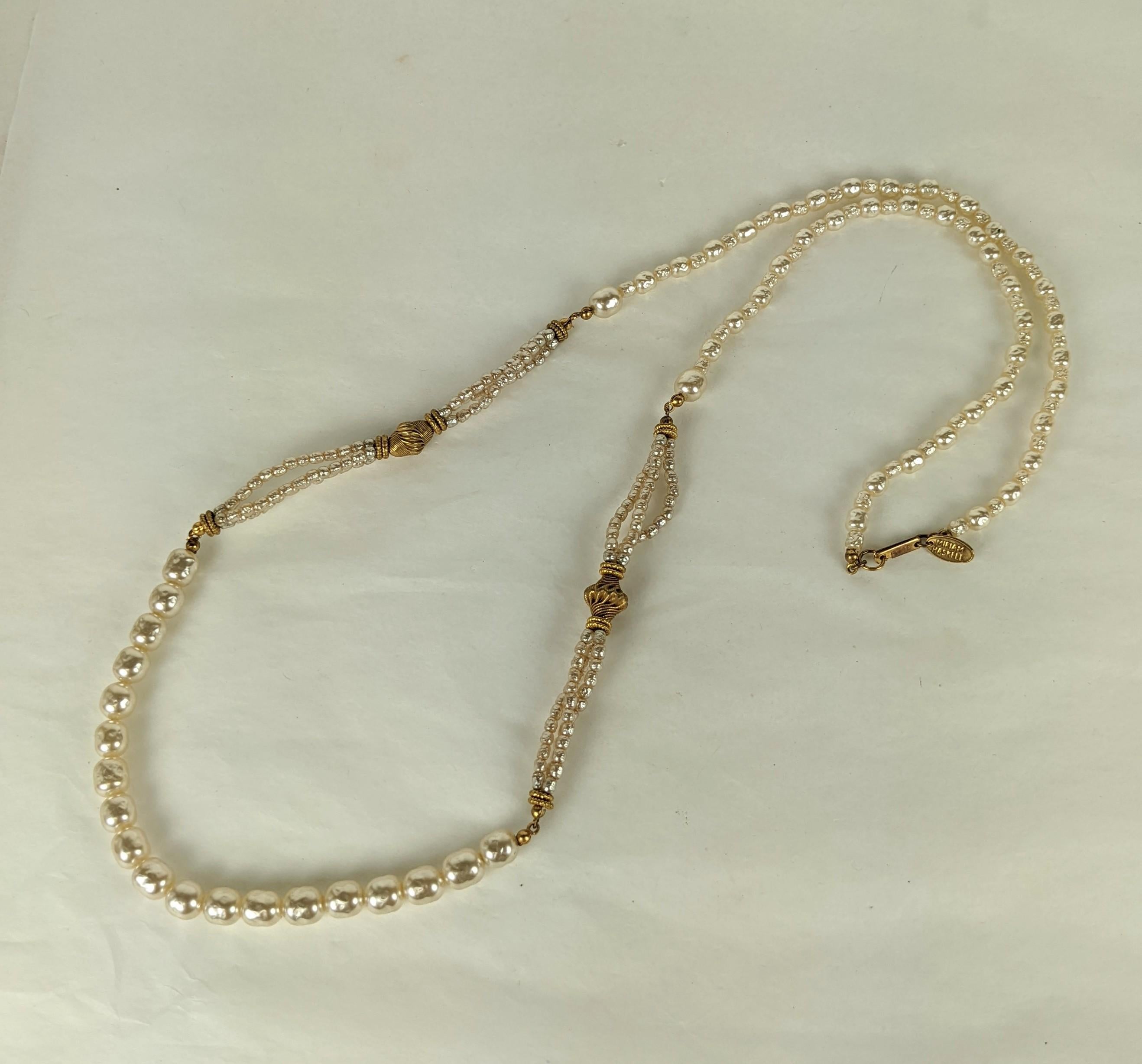 Miriam Haskell classic faux baroque pearl and Russian Gilt plate necklace. Composed of a single pearl strand with four smaller triple strand stations enhanced by Russian Gilt twisted brass spacers and gilt plate cut steel beads. Signed.  Excellent