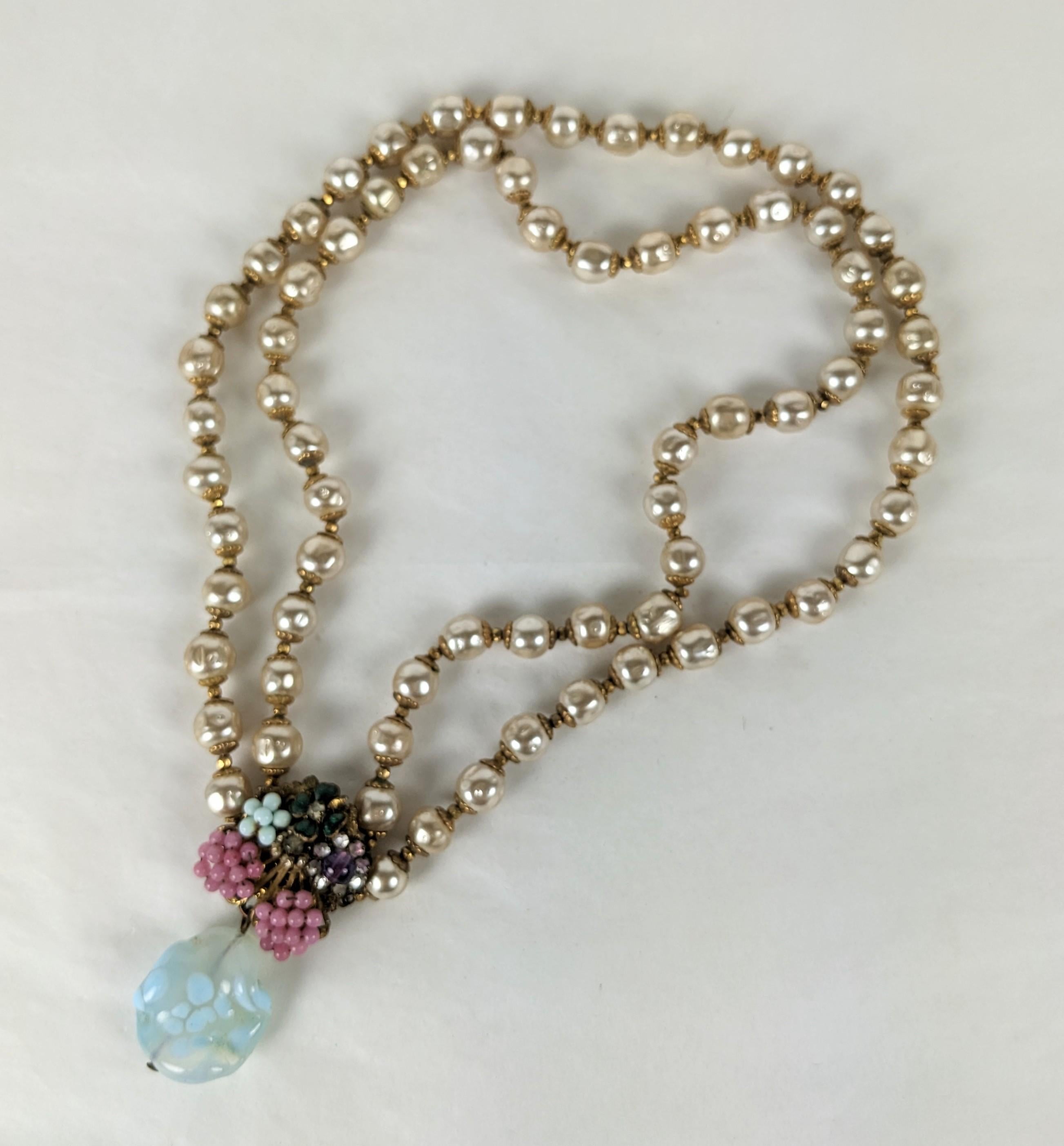Miriam Haskell Pearl Necklace with Pate de Verre, Seed Pearl Pendant from the 1940's. Signature Haskell pearls with gilt spacers. The clasp forms the centerpiece with glass seed beads, enamel clover, rose montees and an aquamarine pate de verre