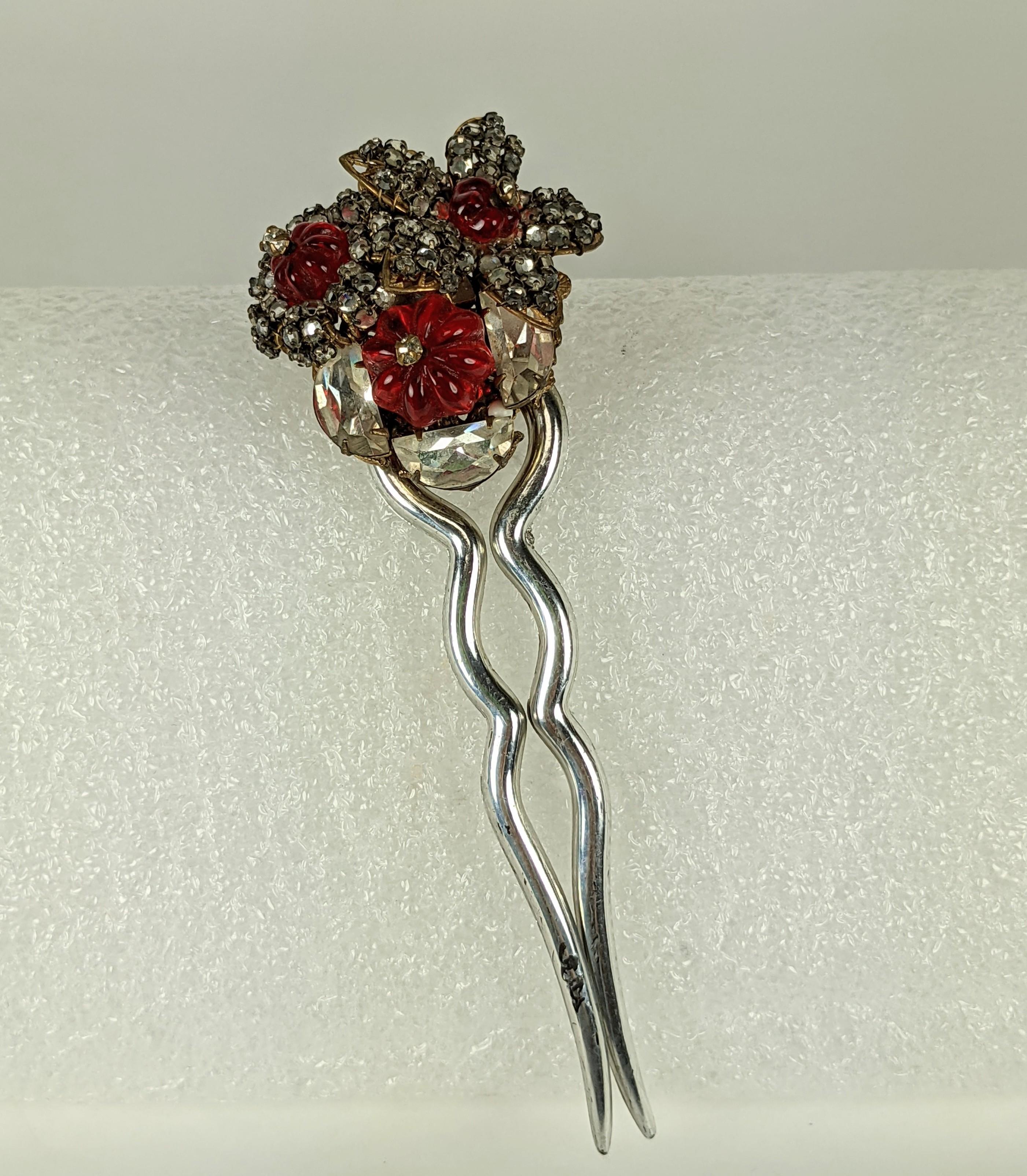 Rare Miriam Haskell hair comb of ruby Gripoix glass melon cut beads, crystal demi lune stones and small crystal rose montes. All hand set and sewn to a signature gilt plate filigree backing.  The two tooth comb of silver clad galaith plastic. 1950's