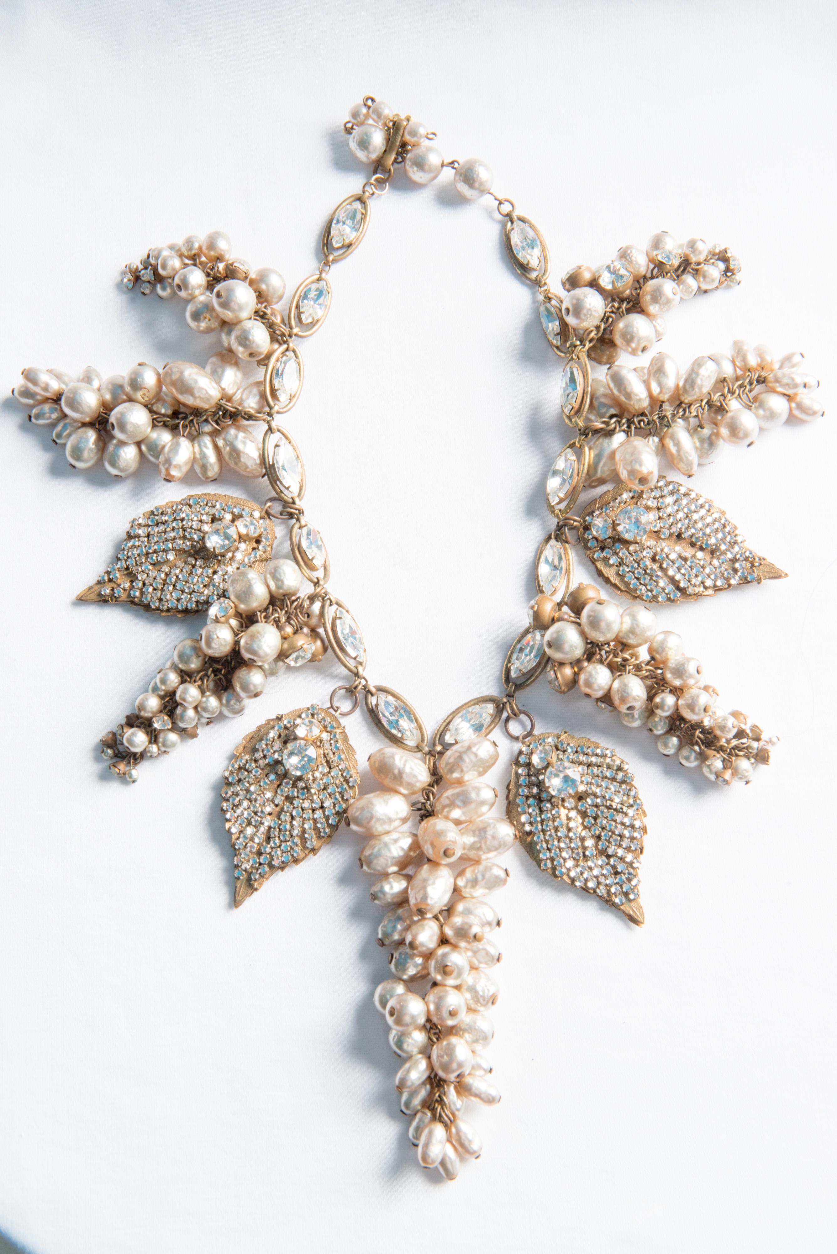 A stunning Miriam Haskell rhinestone gilt leaves and silvered pearl necklace and earring set.
Earrings are 1.25