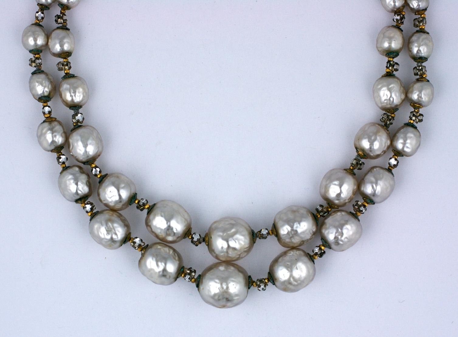 Miriam Haskell Rose Montee and Graduated Pearl Necklace. Lovely signature Miriam Haskell graduated faux pearls with crystal rose montees hand sewn between each pearl. Great creamy color. Signature Miriam Haskell diamonte sewn clasp.
Signed on clasp.