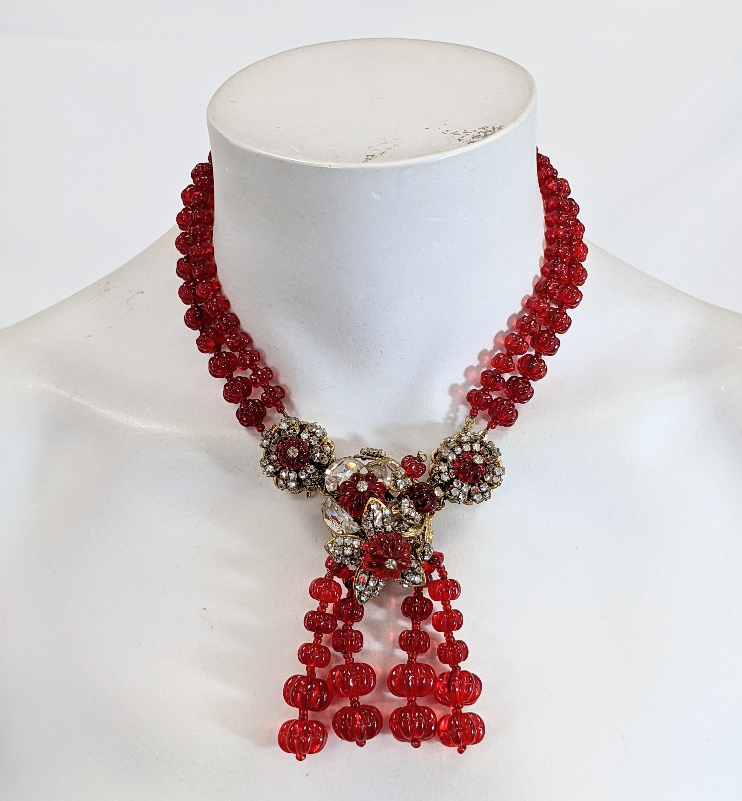 Rare and collectible Miriam Haskell Anglo Indian inspired two strand ruby Gripoix glass melon bead cascade fringed choker necklace. Of signature Russian gilt filigree backings with hand sewn demi lune crystals and crystal rose montes forming