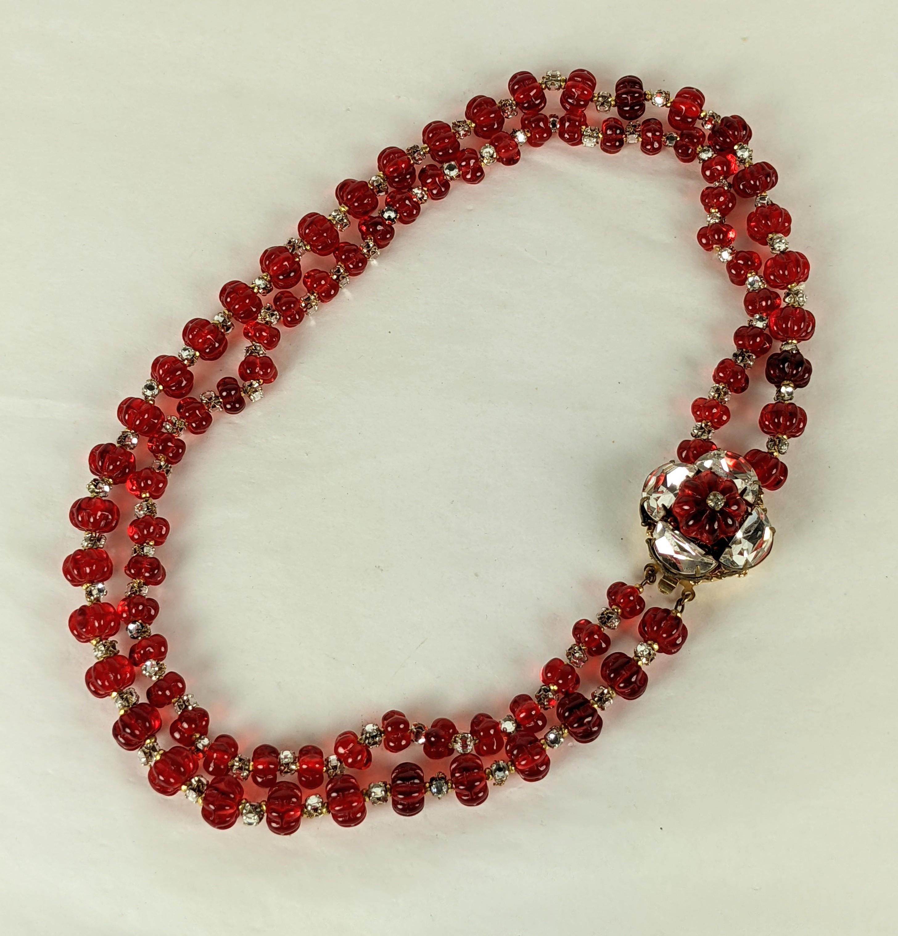 Rare and collectible Miriam Haskell Anglo Indian inspired two strand ruby Gripoix glass melon bead choker necklace. Of signature Russian gilt filigree backings with hand sewn demi lune crystals and crystal rose montes forming flower head clasp. The