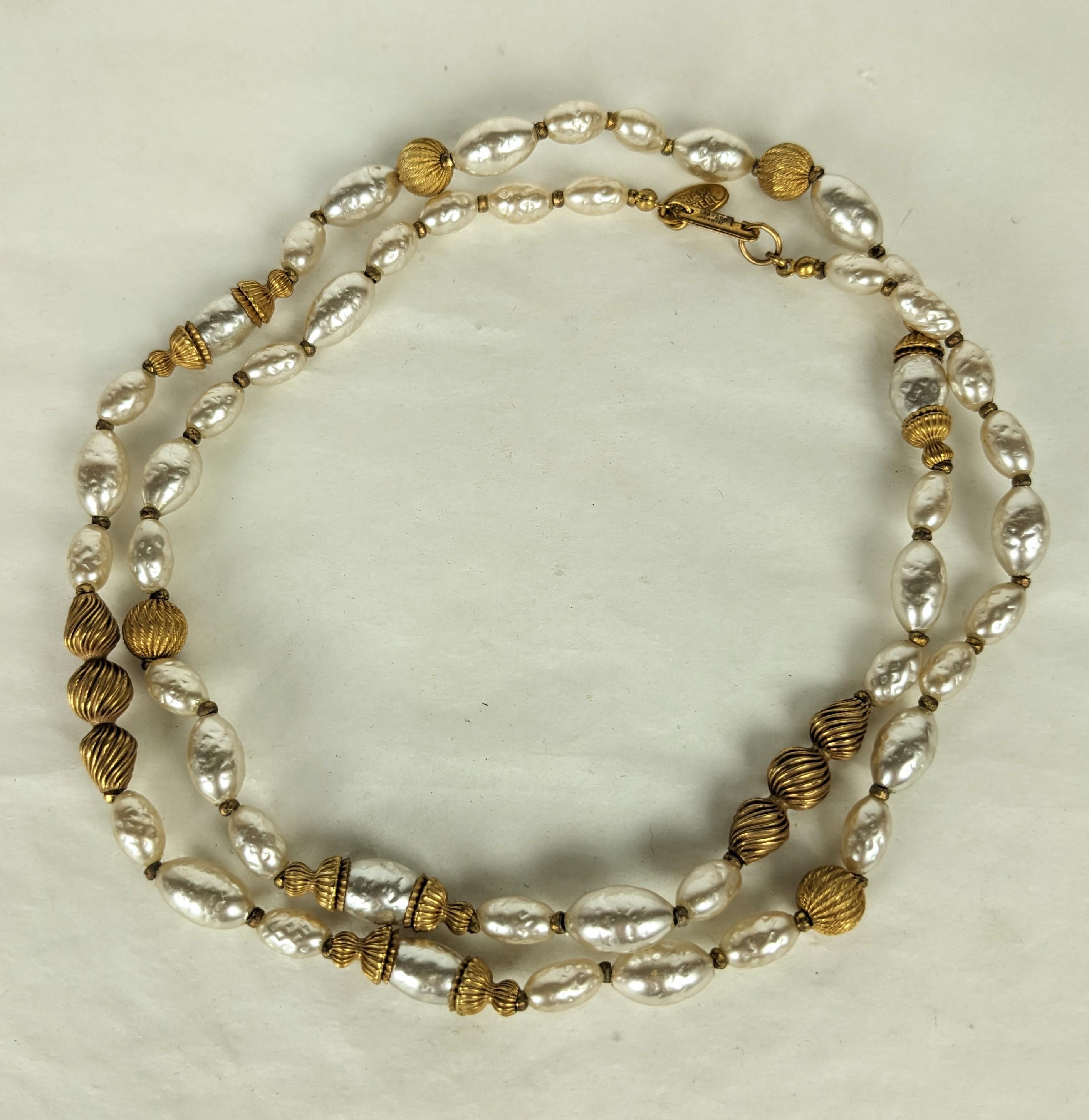Miriam Haskell signature faux baroque rice pearl and Russian Gilt long necklace. Composed of vari size rice shaped pearls and corrugated bead caps, stacked stations and round beads with gilt plate cut steel bead spacers. Excellent Condition,