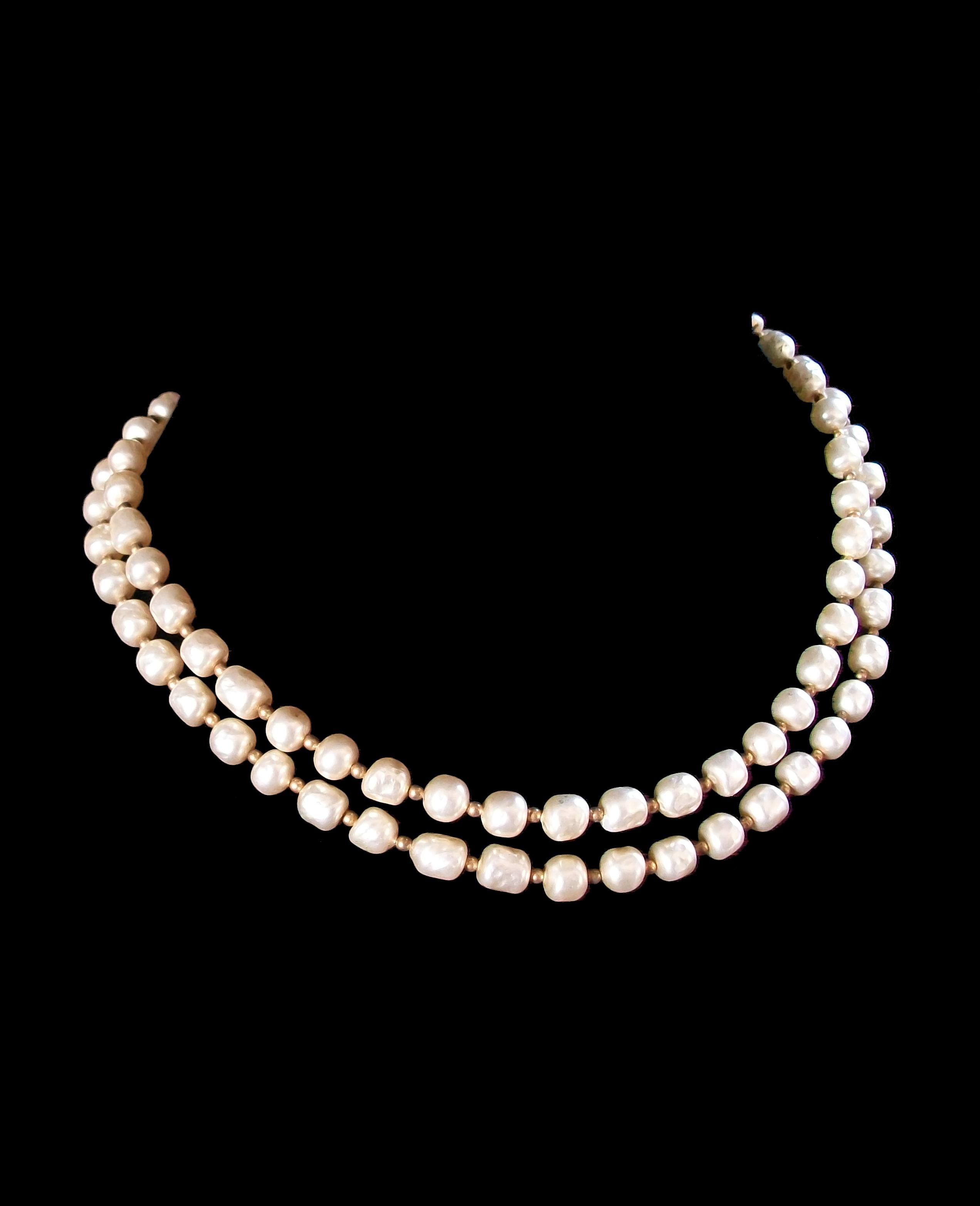 Miriam Haskell style faux baroque pearl necklace - brass bead spacers - can be worn as a single strand or double strand (as photographed) - unsigned - United States - circa 1960's.

Excellent vintage condition - likely re-strung with a replaced hook