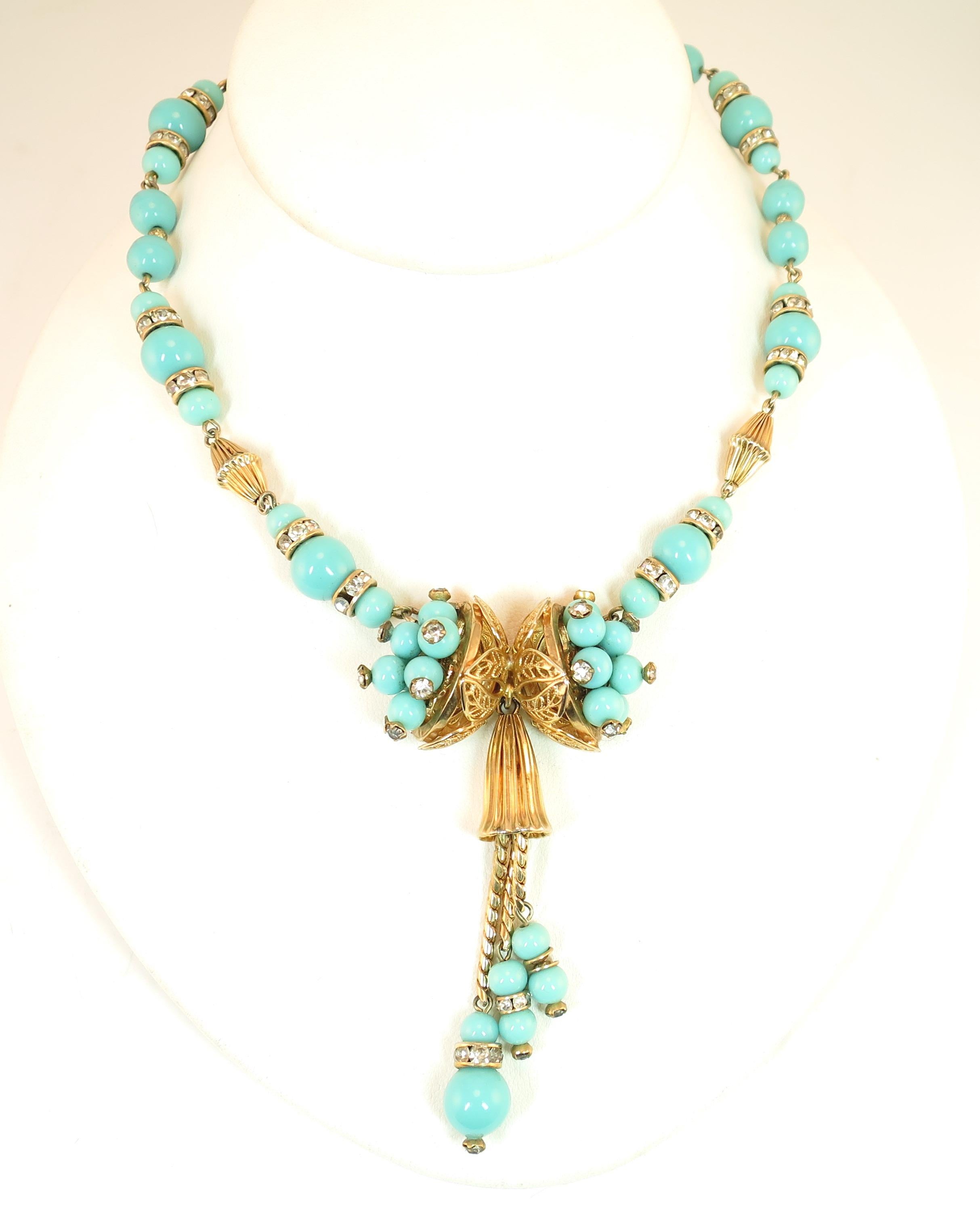 Offered here is a Miriam Haskell turquoise glass gold-plated necklace and bracelet set, made in Germany in the 1950s. The components for both pieces are alike, but the design expression for each item is its own, within the theme. The necklace has a