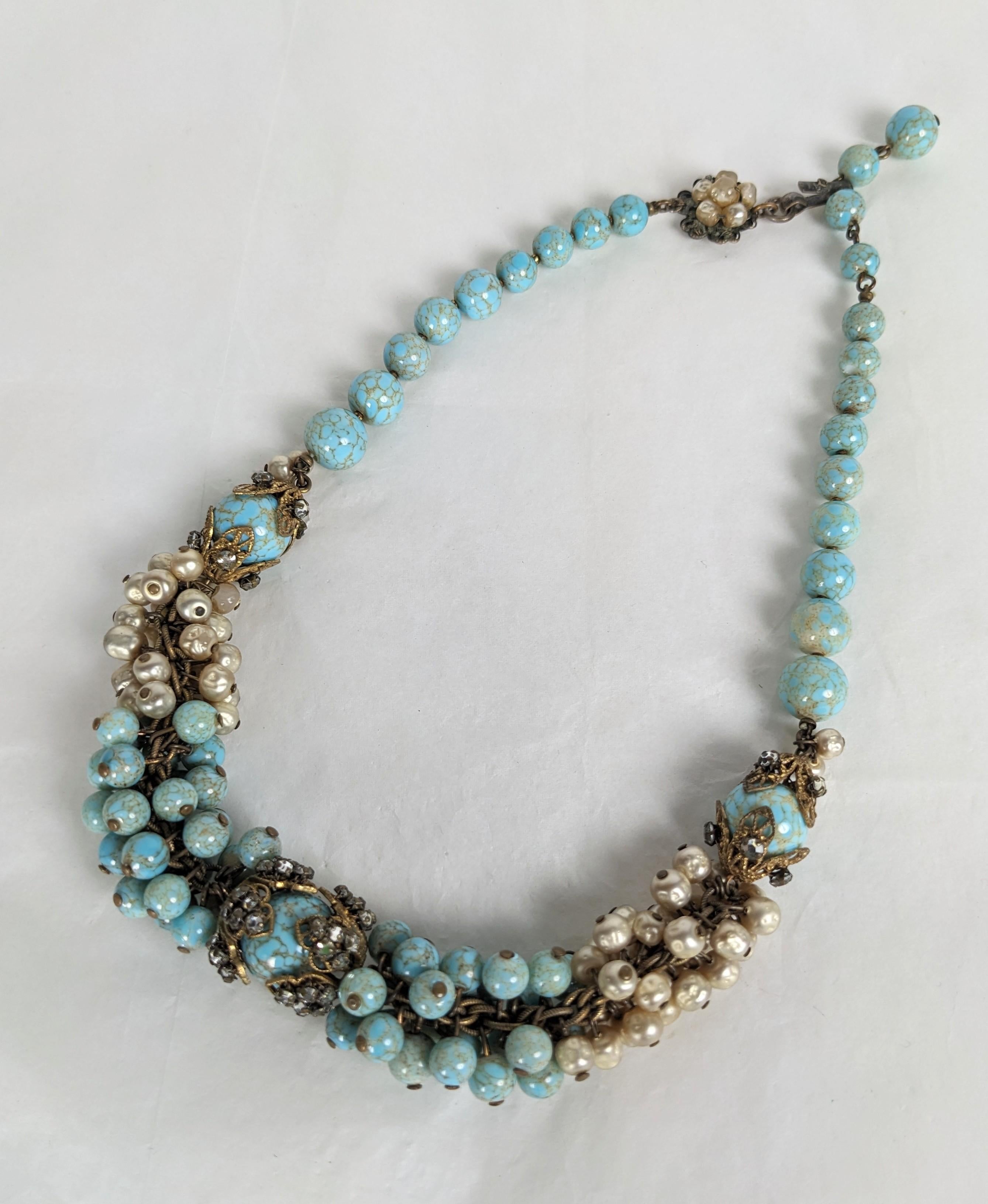 Lovely Miriam Haskell Turquoise Pate de Verre and Faux Pearl Beaded Collar from the 1950's. Composed of signature faux pearls with pate de verre Gripoix glass turquoise beads. Brass Filigree caps are sewn with crystal rose montee accents. Signed on