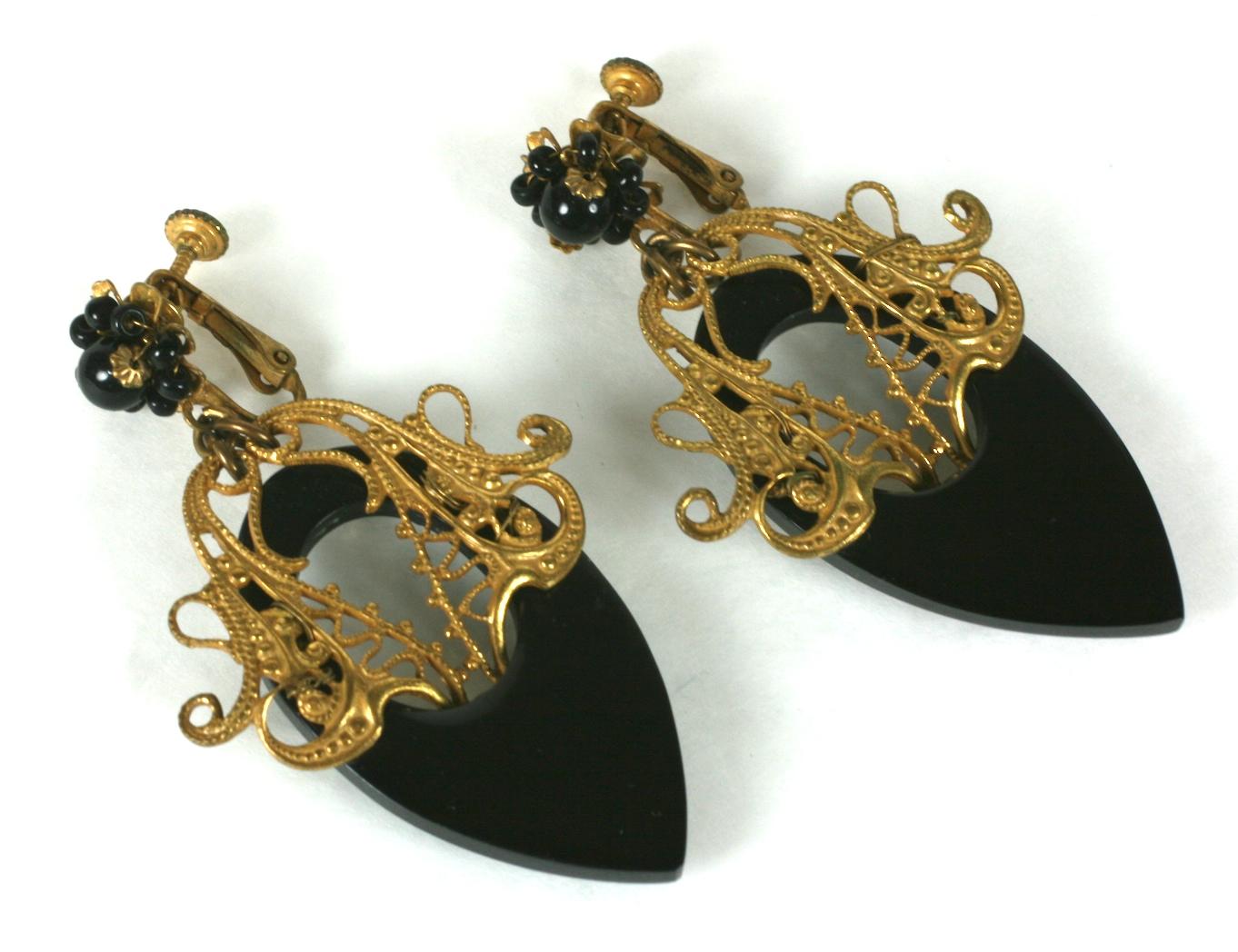 Large and attractive Miriam Haskell Victorian Revival Jet Earrings in signature Russian gilt finish. Gilt filigrees are mounted on black resin drops with seed pearl accents. Clip back fittings. 1950's USA.
2.75