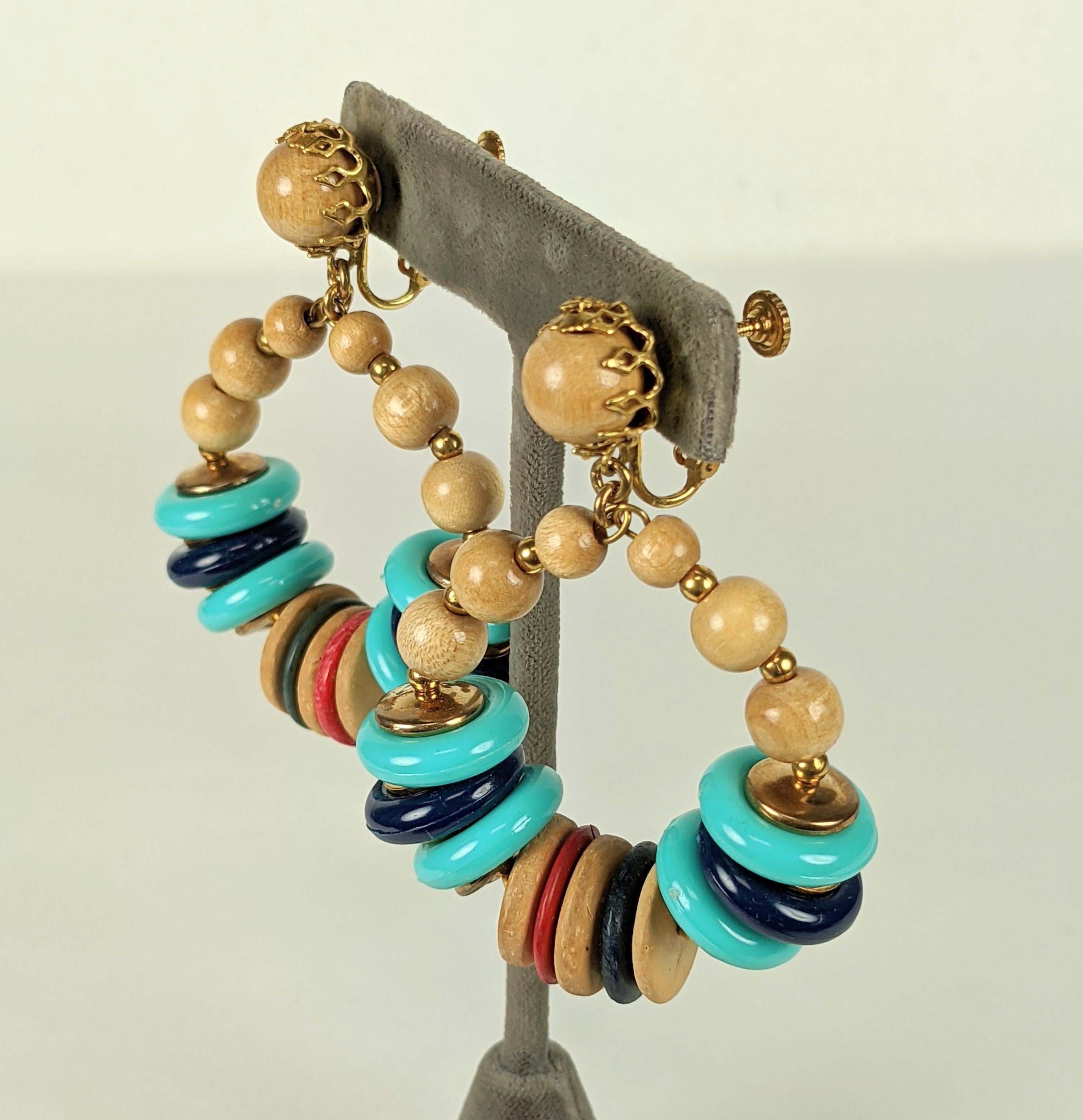 Striking Miriam Haskell Hoop Earrings composed of wood, stained wood, resin and gilt beads. Adjustable clip back fittings.  1960's USA. 
2.5