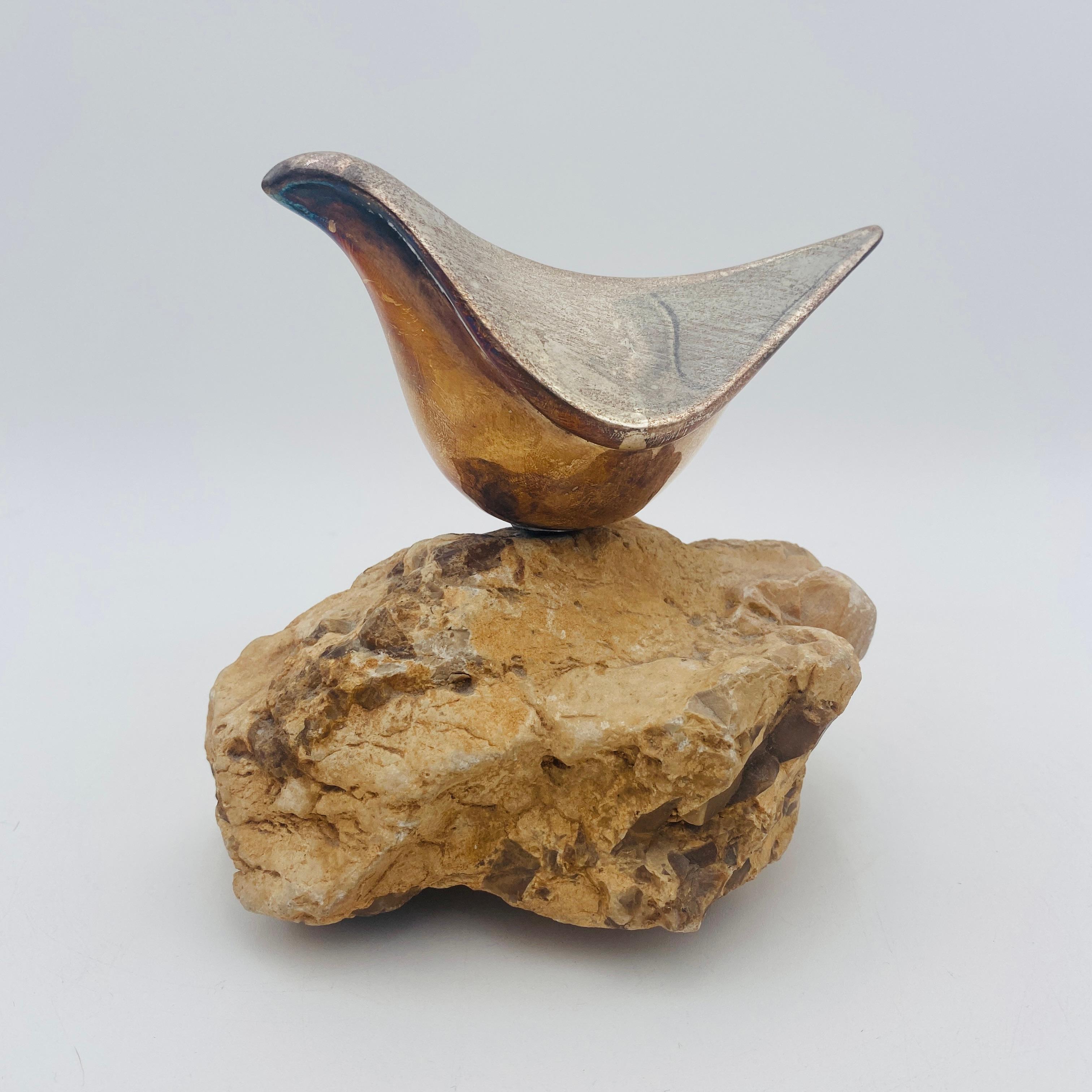 This is a beautiful bird sculpture by Miriam Hirszowicz. The sculpture is an abstract form of a dove perched on a stone. It has a nice patina but could also be polished to bring out the silver. The silver is signed M.H. 925. 