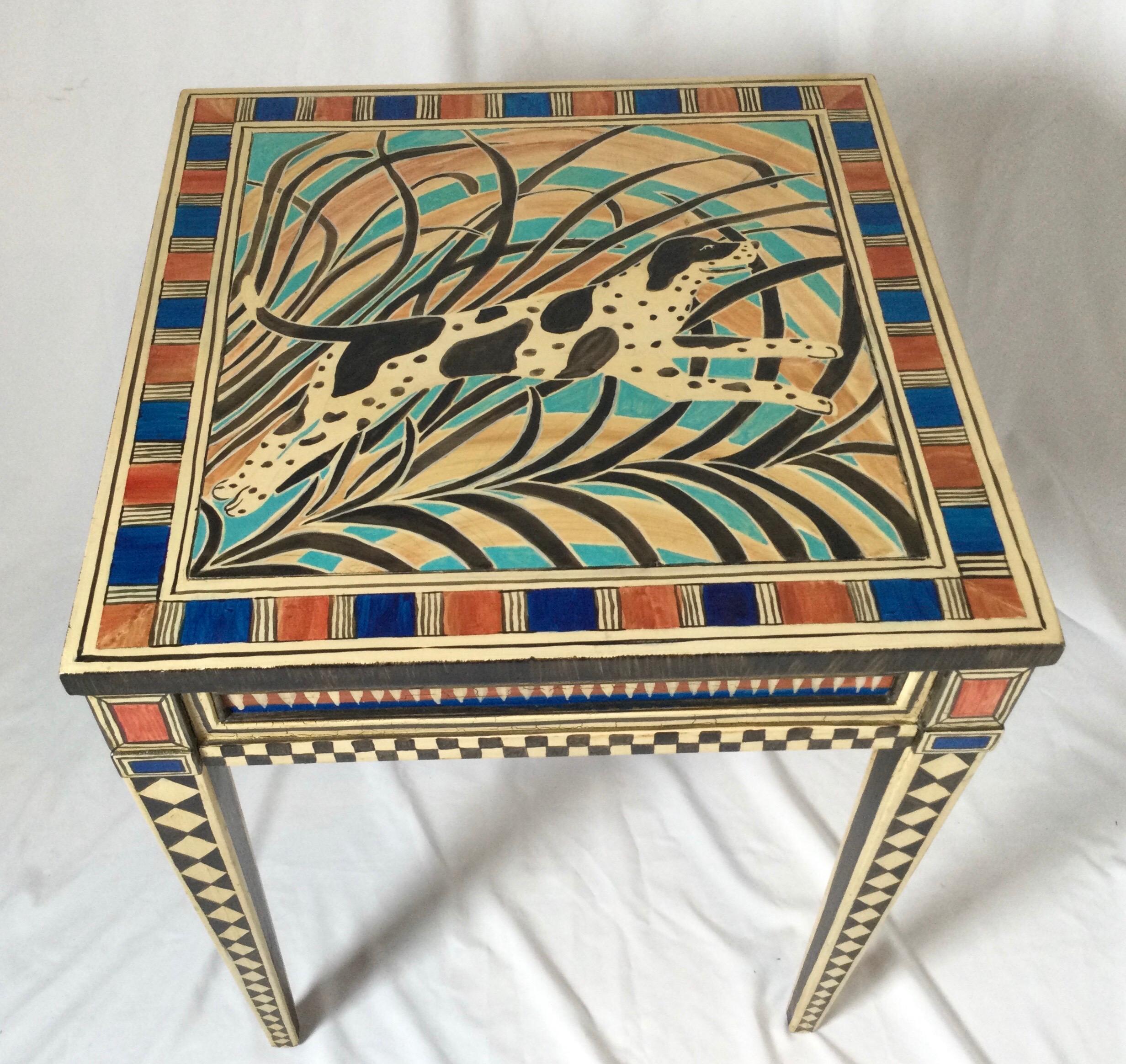 One of a kind! The top depicts a leaping spotted dog, edge banded by blue and rust pattern. Tapered legs with diamond pattern from top to bottom. Table made by Brant Furniture Co. Stands 20 3/4