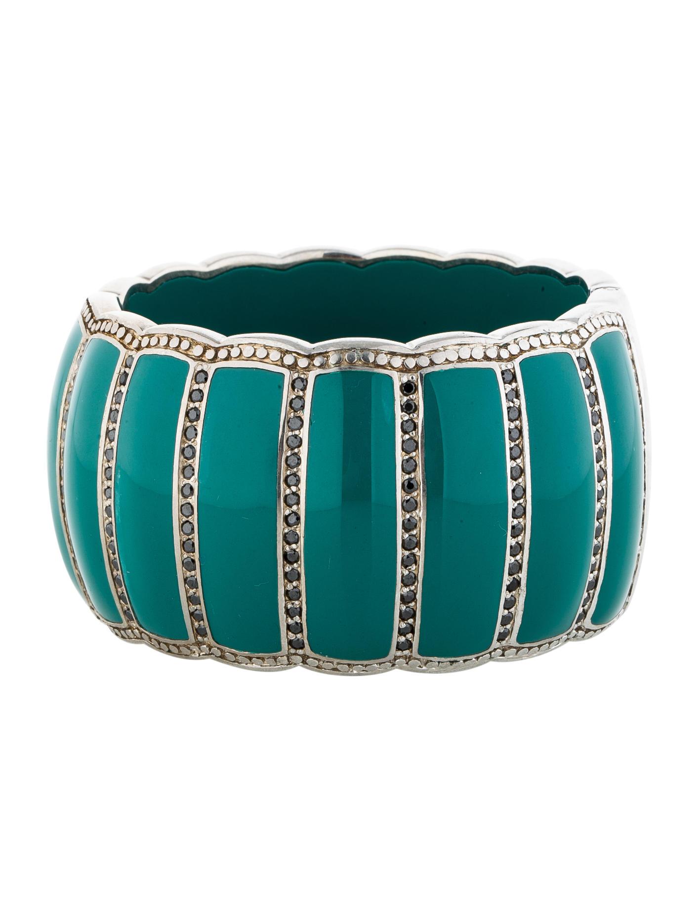 Miriam Salat Turquoise resin and sterling silver cuff bracelet features a scalloped design with bead set black topaz embellishments. 
Cuff measures apx. 6-1/2 inches in circumference and apx. 1-3/4 inches in width. 
Cuff  has a magnetic opening and