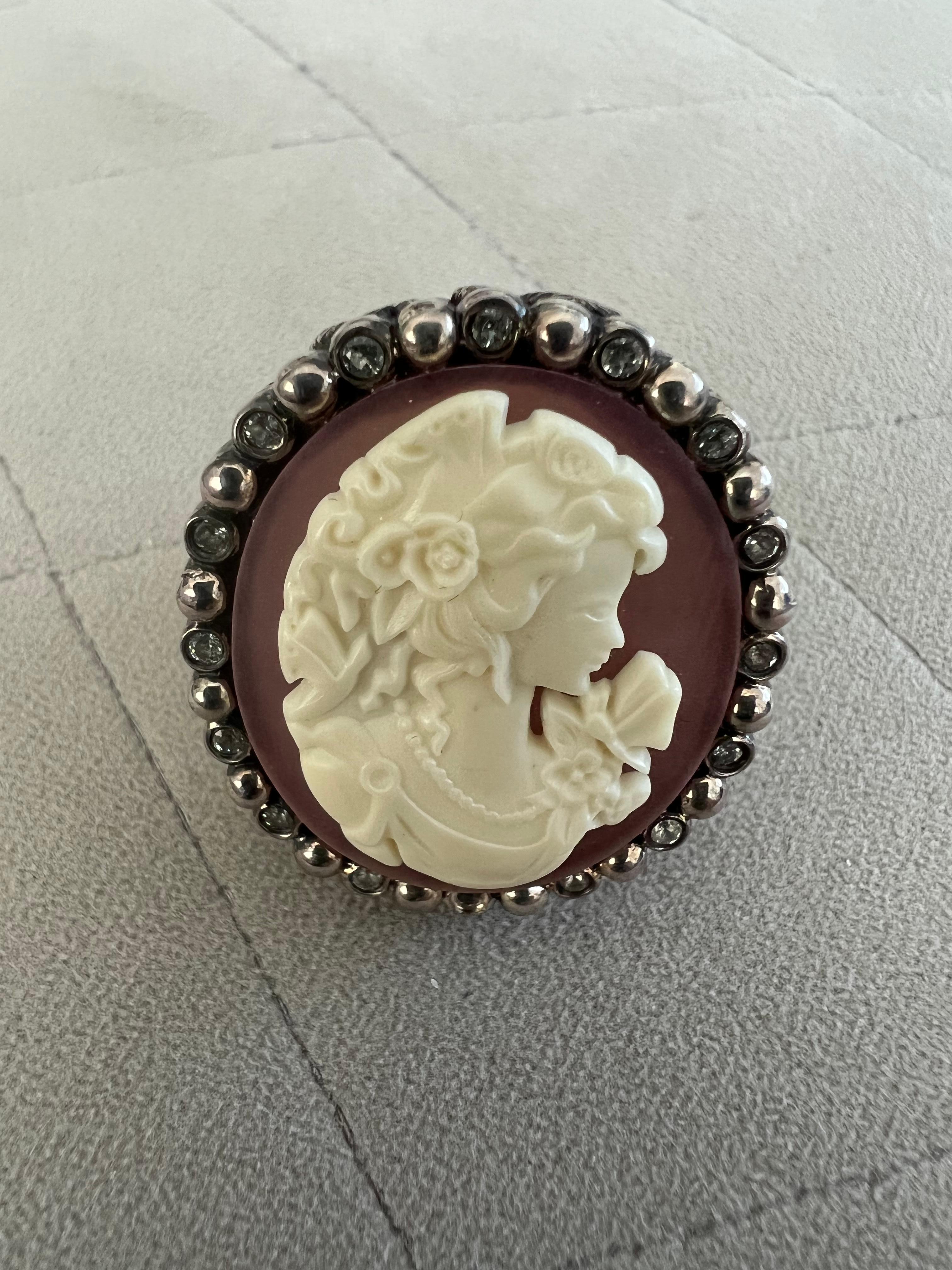 Miriam Salat Cameo ring features milky cream and pink resin with vintage sterling silver. 
Topaz full diamond facet rounds, prong set.
Total weight is approx 50 grams. 
Signed 