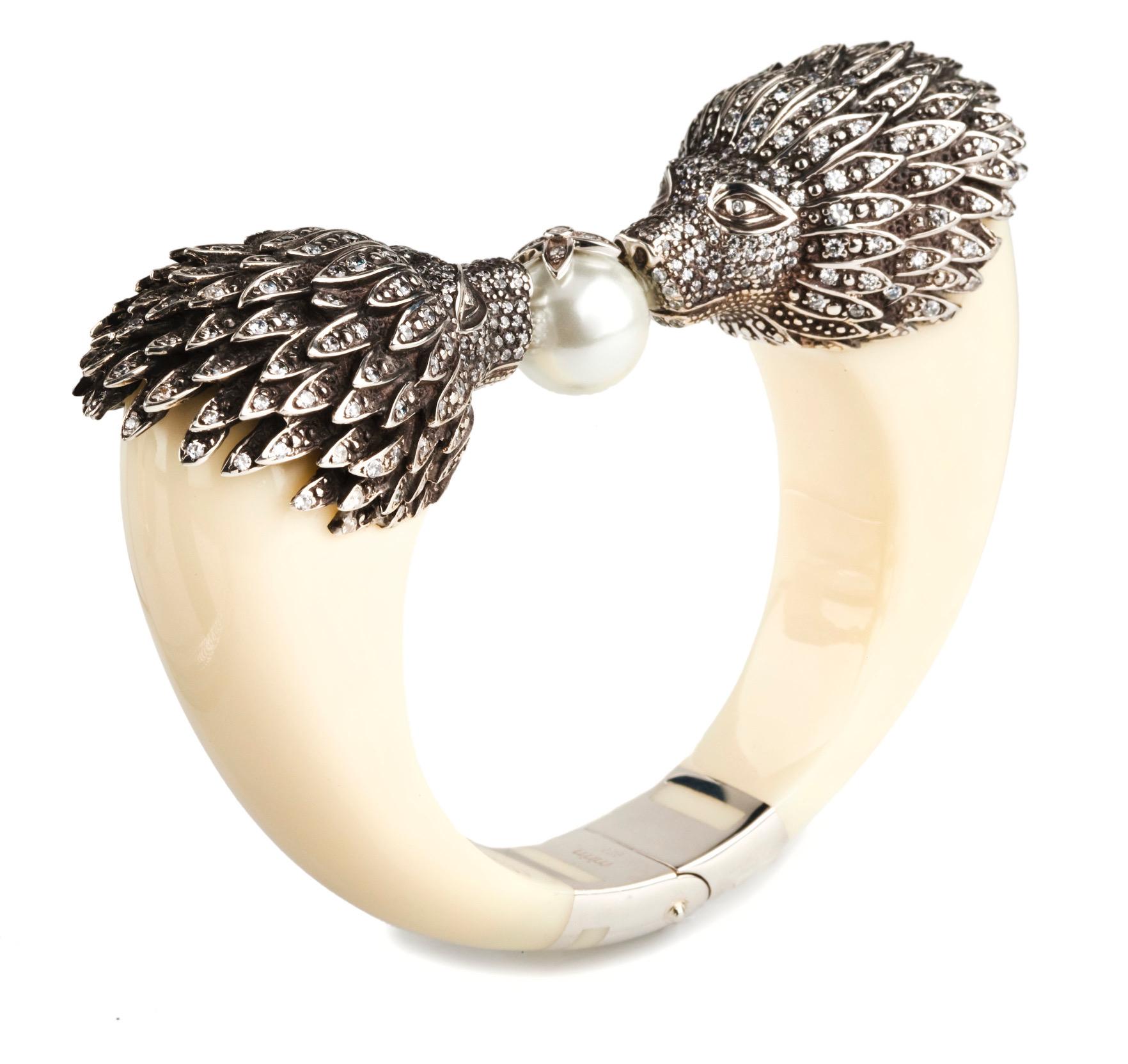 This Miriam Salat limited edition lion head bangle features cream and ivory color resin with vintage sterling silver. 
Cubic zircon full diamond facet rounds, prong set.
This cuff is set to feel and look like fine jewelry. 
Bangle is flexible to fit