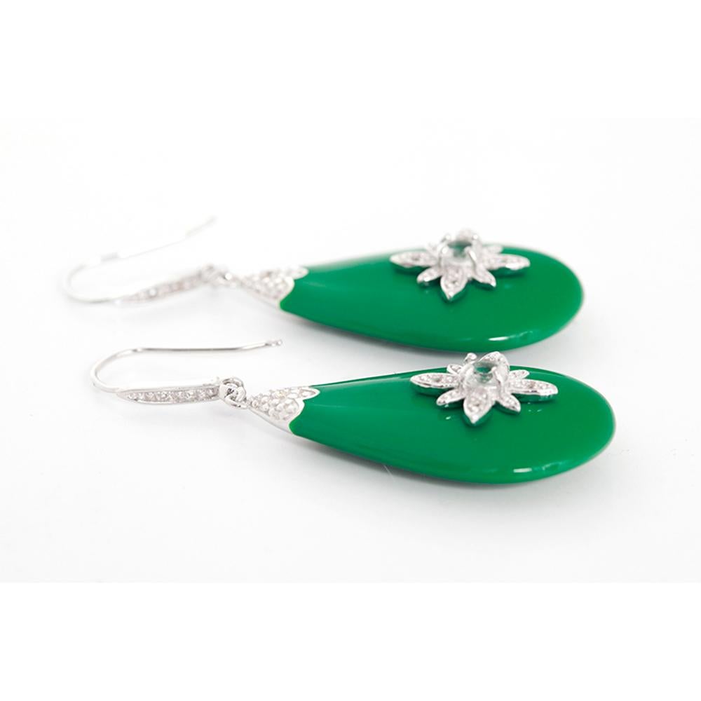 These Miriam Salat Starburst earrings feature channel set topaz embellishments at bail, prong set topaz accents at drop set in sterling silver on green resin with French hook closures. Earrings measure apx. 2.5 inches in length and 1-inch in width.