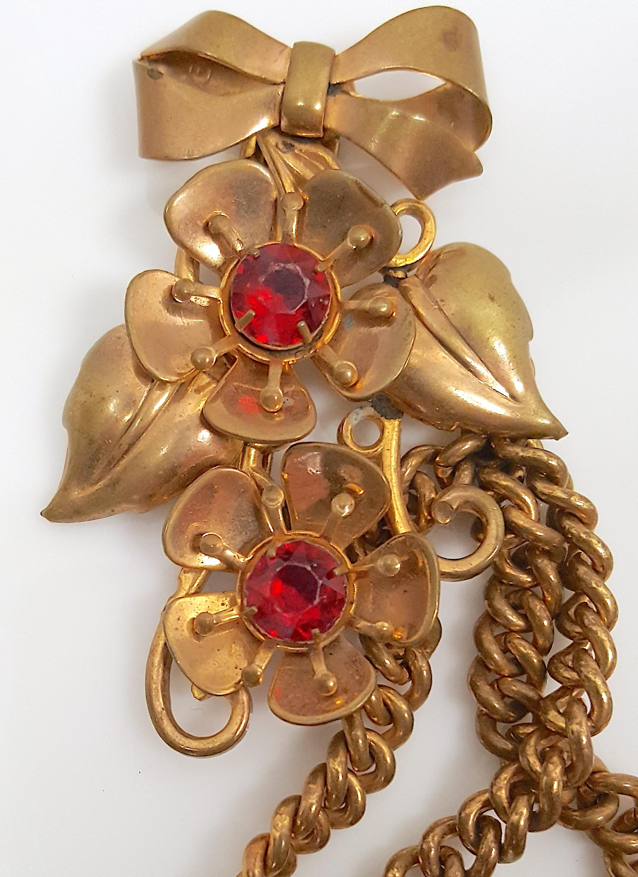 As one of Miriam Haskell's earliest fur clips from the late 1920s, these two Russian-gold gilt mostly brass brooches by her first designer Frank Hess are tethered as a lariat by three long chains, which is similar to a relatively simple all-metal