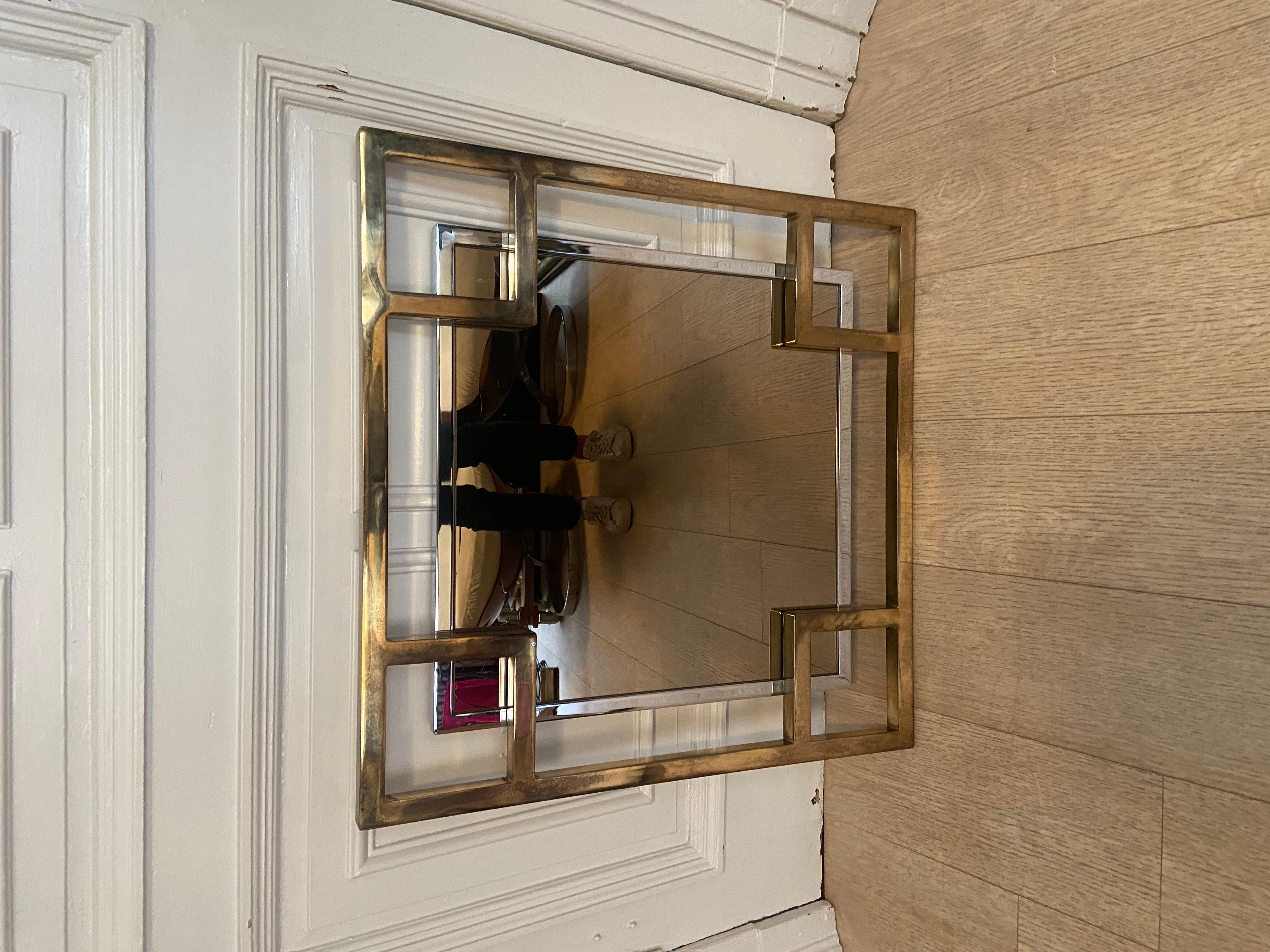 Art deco inspired mirror produced by the belgo chrom factory in the 1970s. Gold and chrome metal. Smoked mirror.
 