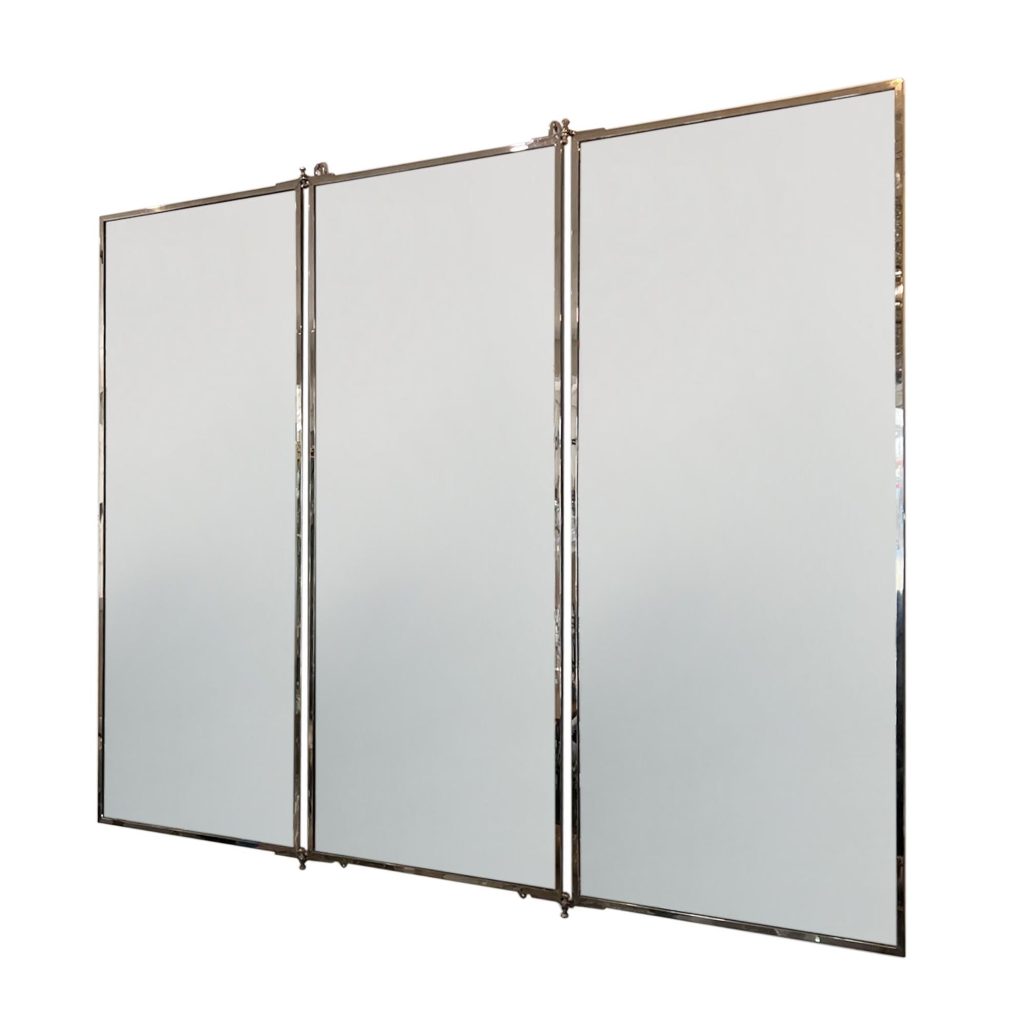 This fantastic triptych wall mirror was made at the Parisian workshops of Miroir Brot in the 1910s.

The mirrors can be folded in or out - our restorer has carefully recovered the screens in a pale silk. The mirror retains it's original maker's