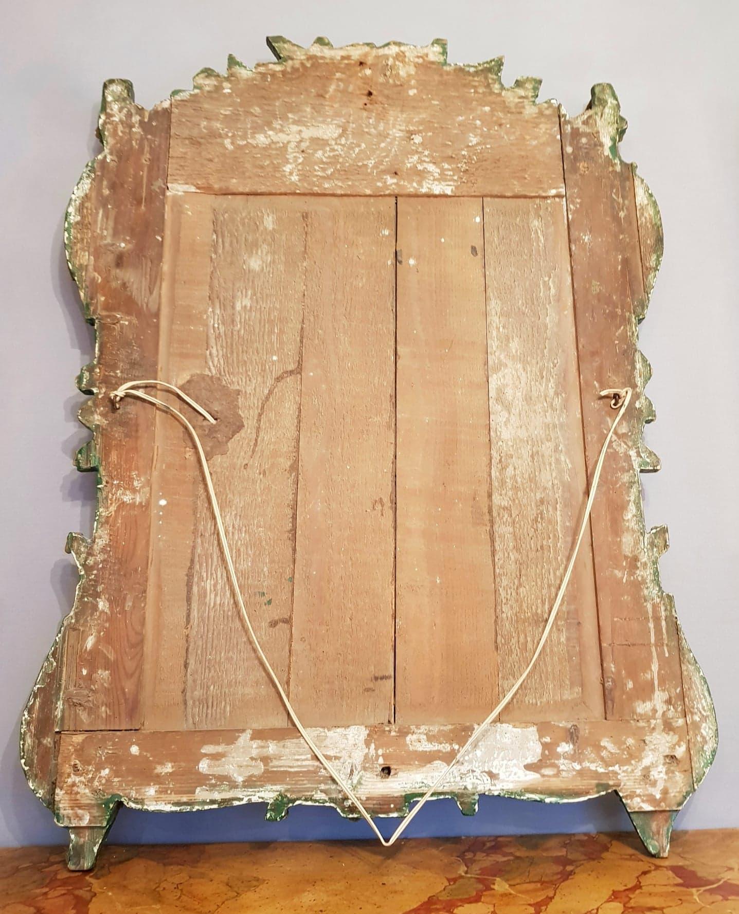 Miroir à fronton d'époque Régence en bois sculpté et doré.
Ce miroir une pièce de belle qualité du début du 18ème siècle.
Le fronton du miroir est joliment sculpté ; il décrit un décors florale, Rocaille, de qualité.
La glace d'origine repose sur