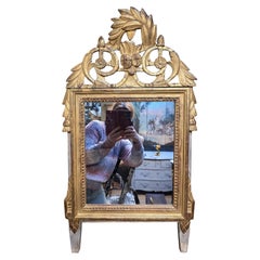 Miroir mural d'époque Louis XVI en bois sculpté et doré