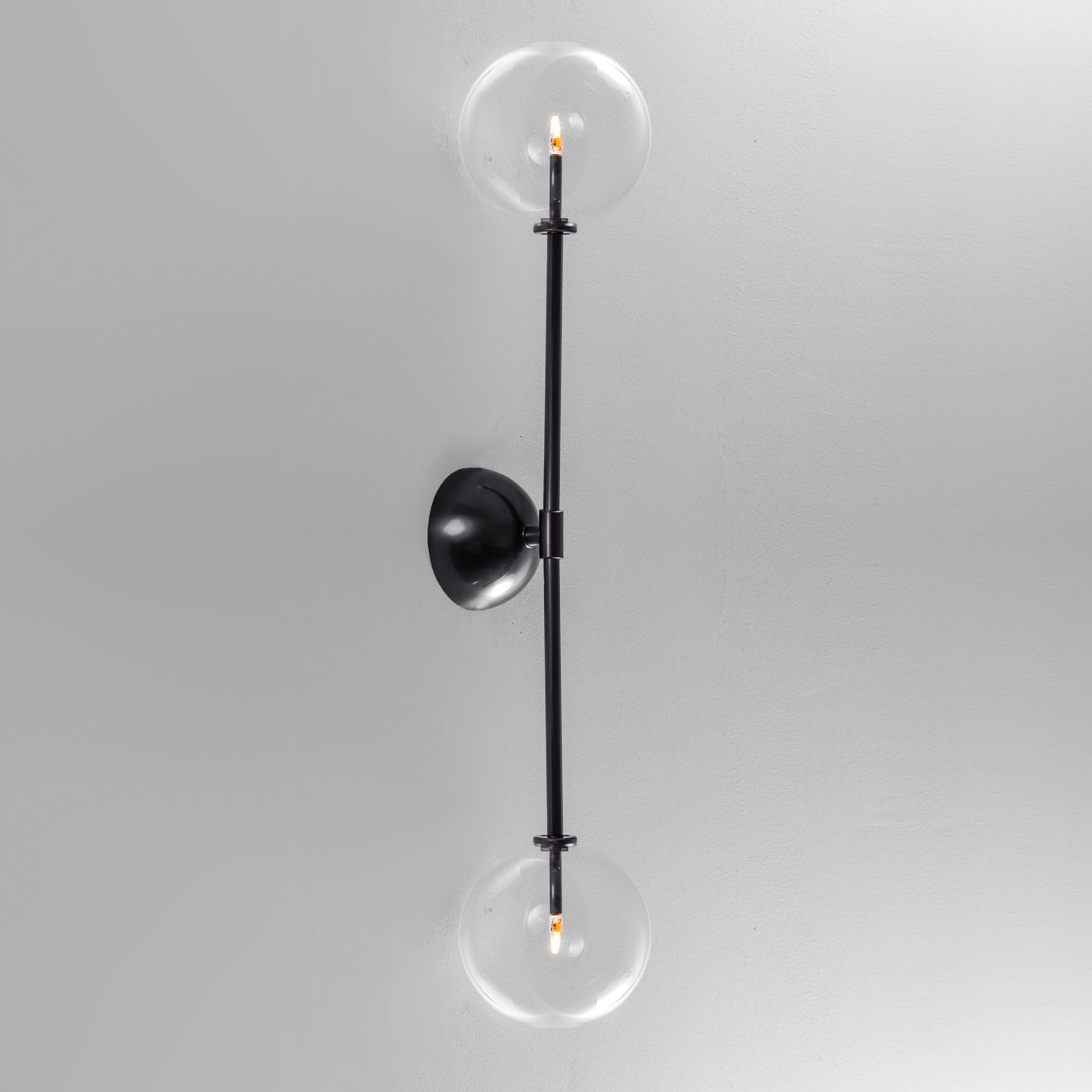 Miron Wall Sconce by Schwung
Dimensions: W 15 x D 16 x H 79 cm
Materials: Black gunmetal, hand blown glass globes

Finishes available: Black gunmetal, polished nickel, brass

Schwung is a German word, and loosely defined, means energy or momentumm