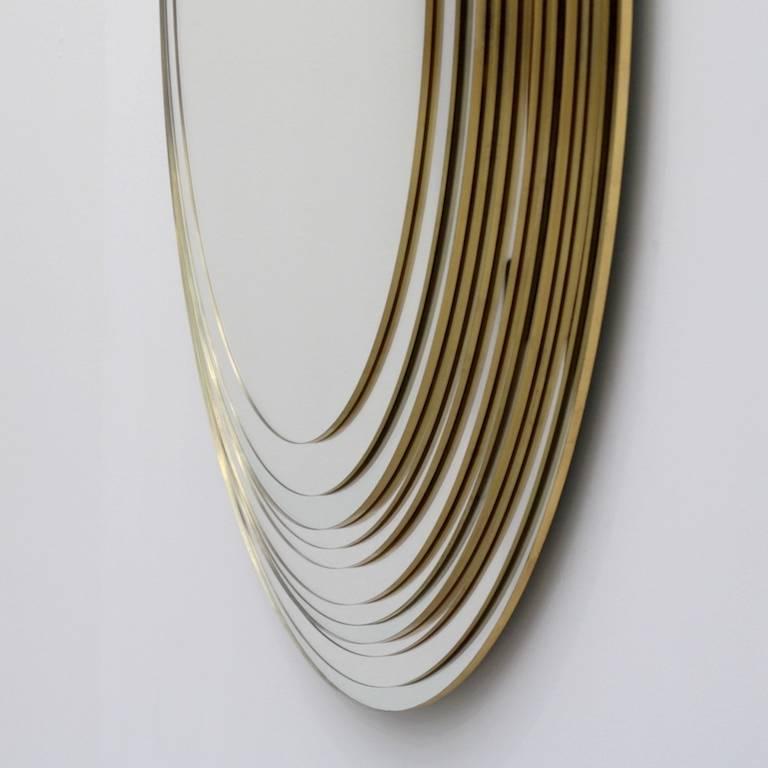 Eleven mirrors superimposed by the Designer Sam Baron, assisted by the glassmaker Yvon Goude, are homothetic declinations multiplying the essential perfect and infinite form of the oval / egg / face. In a subtle and intriguing way, the gold leaf is