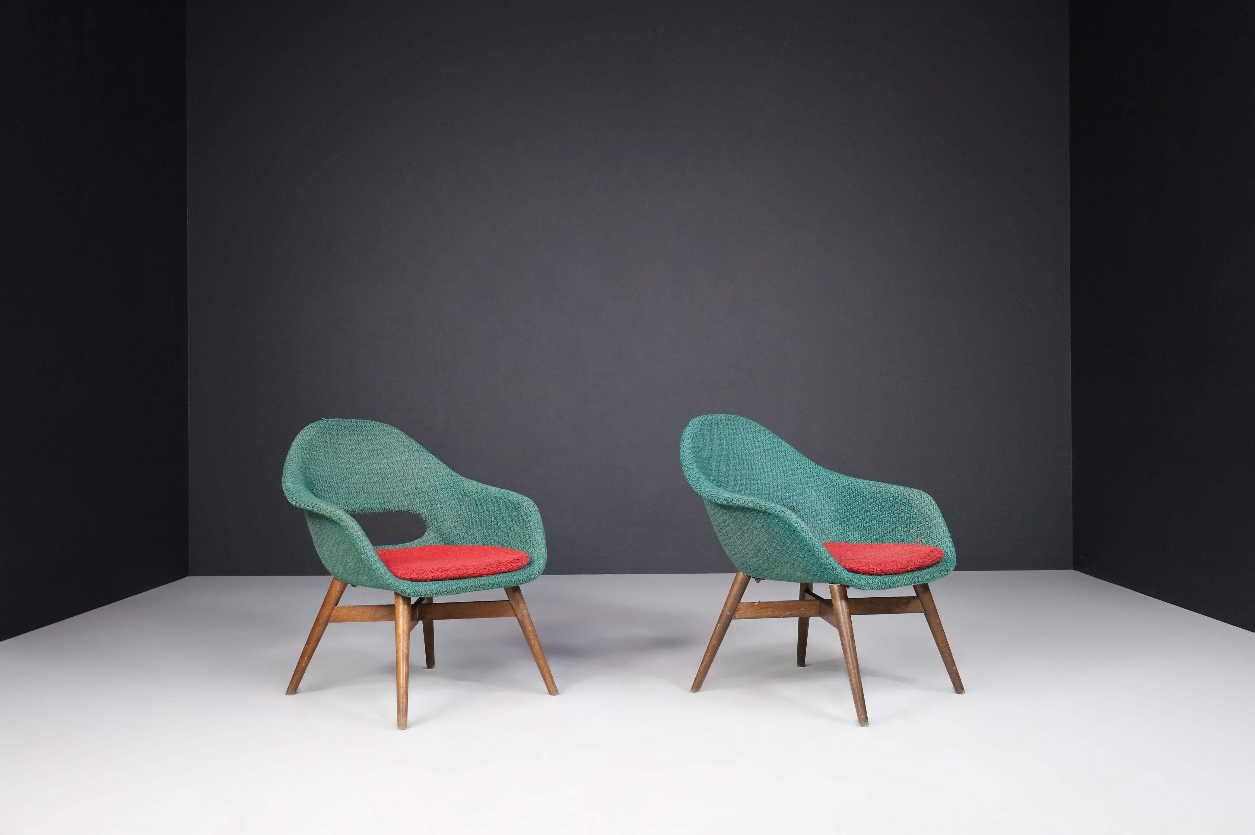 Miroslav Navratil easy chairs in original fabric 1960.

Lovely set of two easy chairs by Miroslav Navratil, manufactured in Czech by Cesky Nabytek circa 1960. These chairs have a brown beech plywood base and a fiberglass shell with original fabric