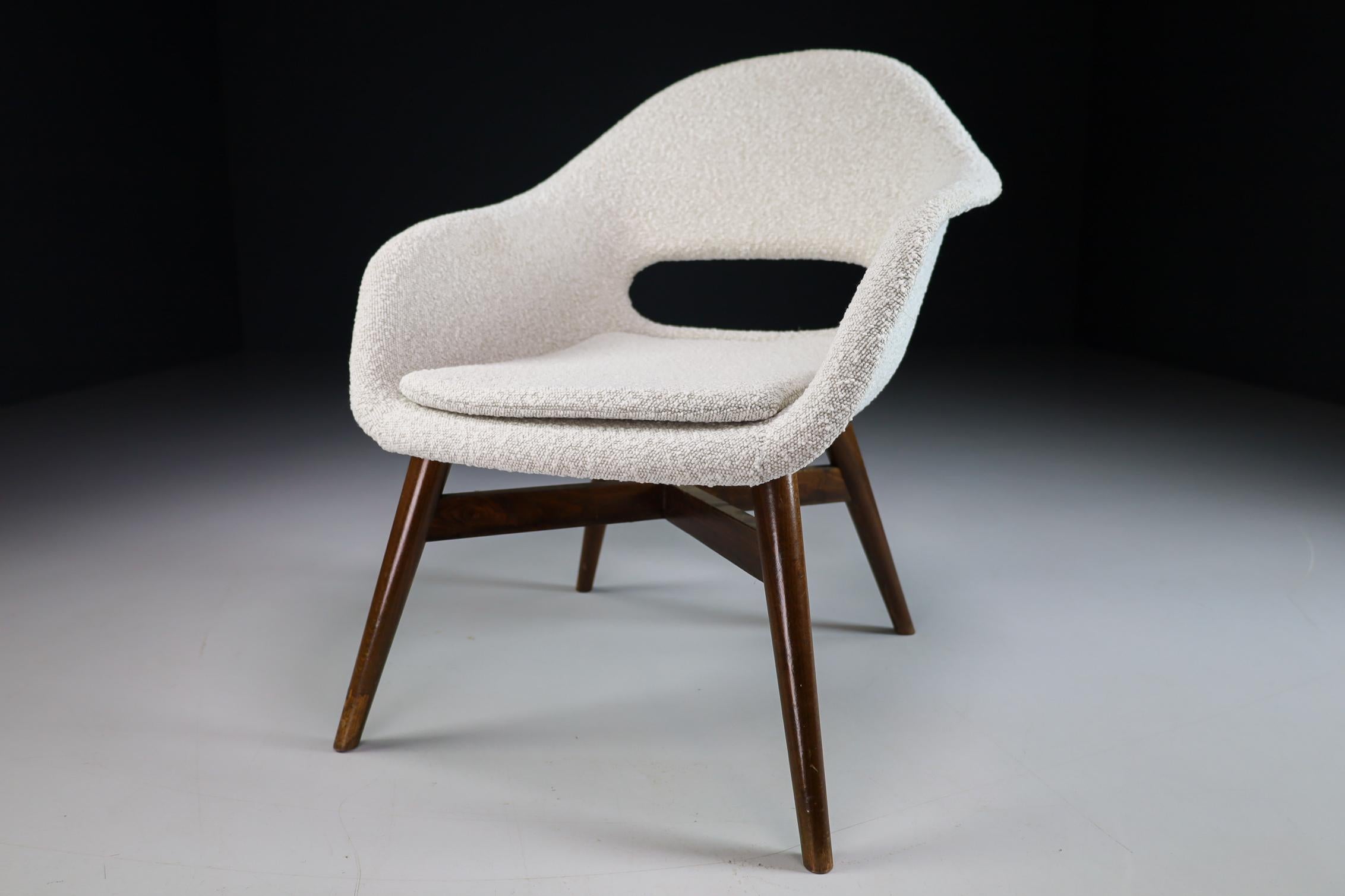 Miroslav Navratil lounge chair with fiberglass shell in new upholstery Bouclé fabric. The wooden base made of stained beech or walnut is also in a very good condition, manufactured in the Czech Republic in the early 1960s. This armchair / lounge