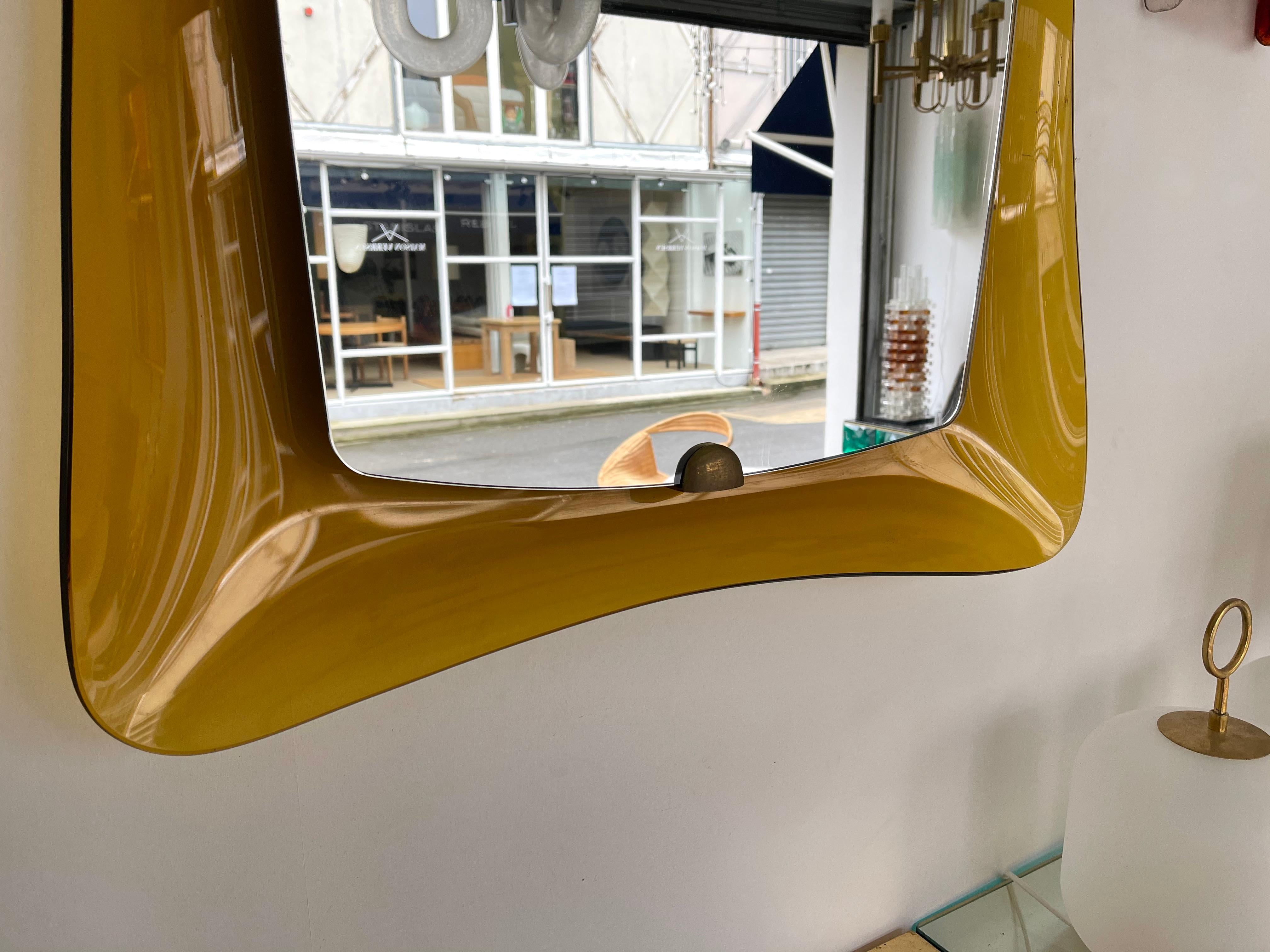 Wall mirror rare amber yellow orange curve glass with round angle, brass details by Cristal Art, the concurrent of Fontana Arte.