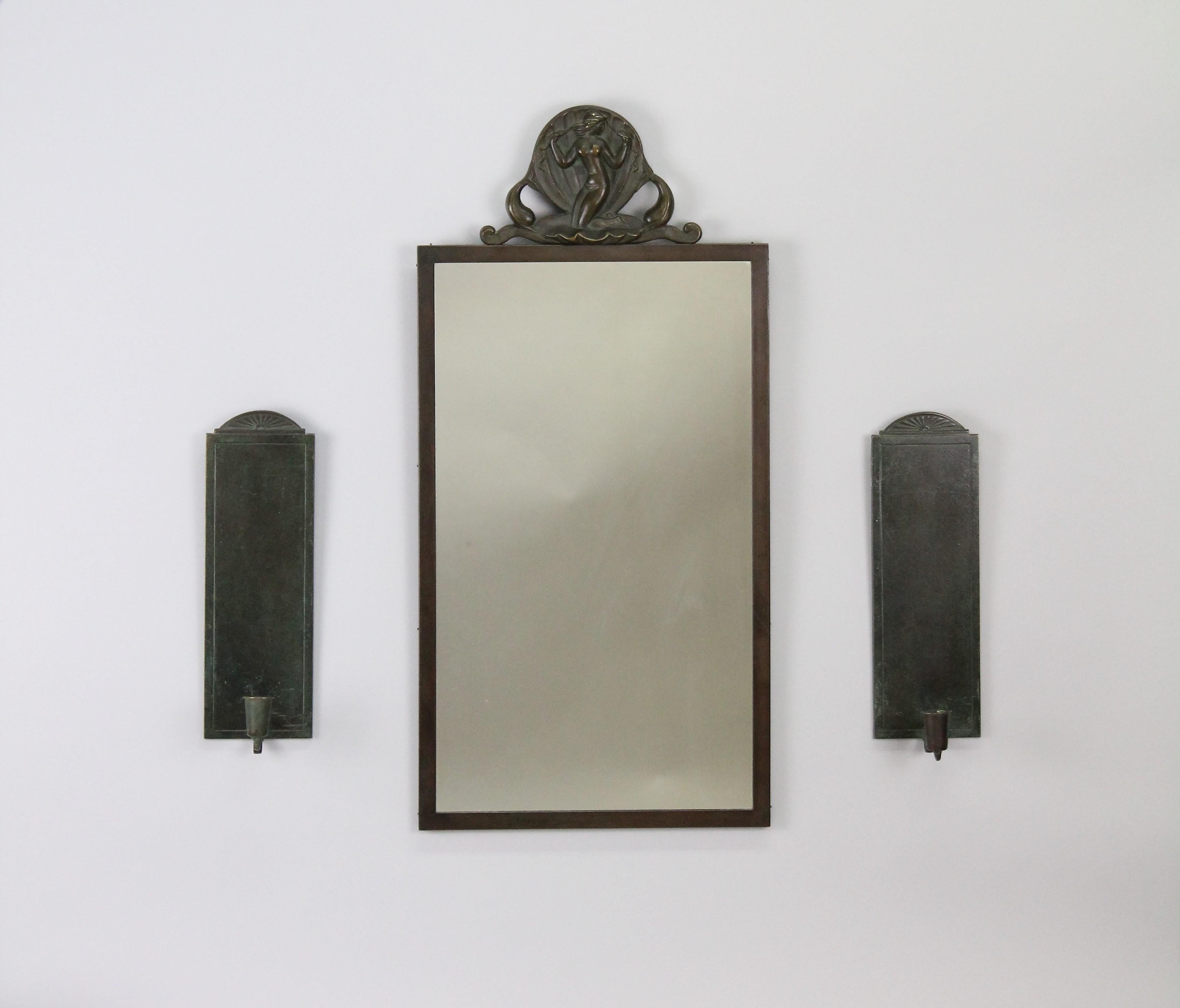 A very nice set of a mirror and a pair of scones.
Made in Sweden by Oscar Antonsson for Ystad Brons in the 1930s.
Very nice original condition, no issues!
Made in bronze which has been patinated in green/brown colors.

Measurement:
Mirror,