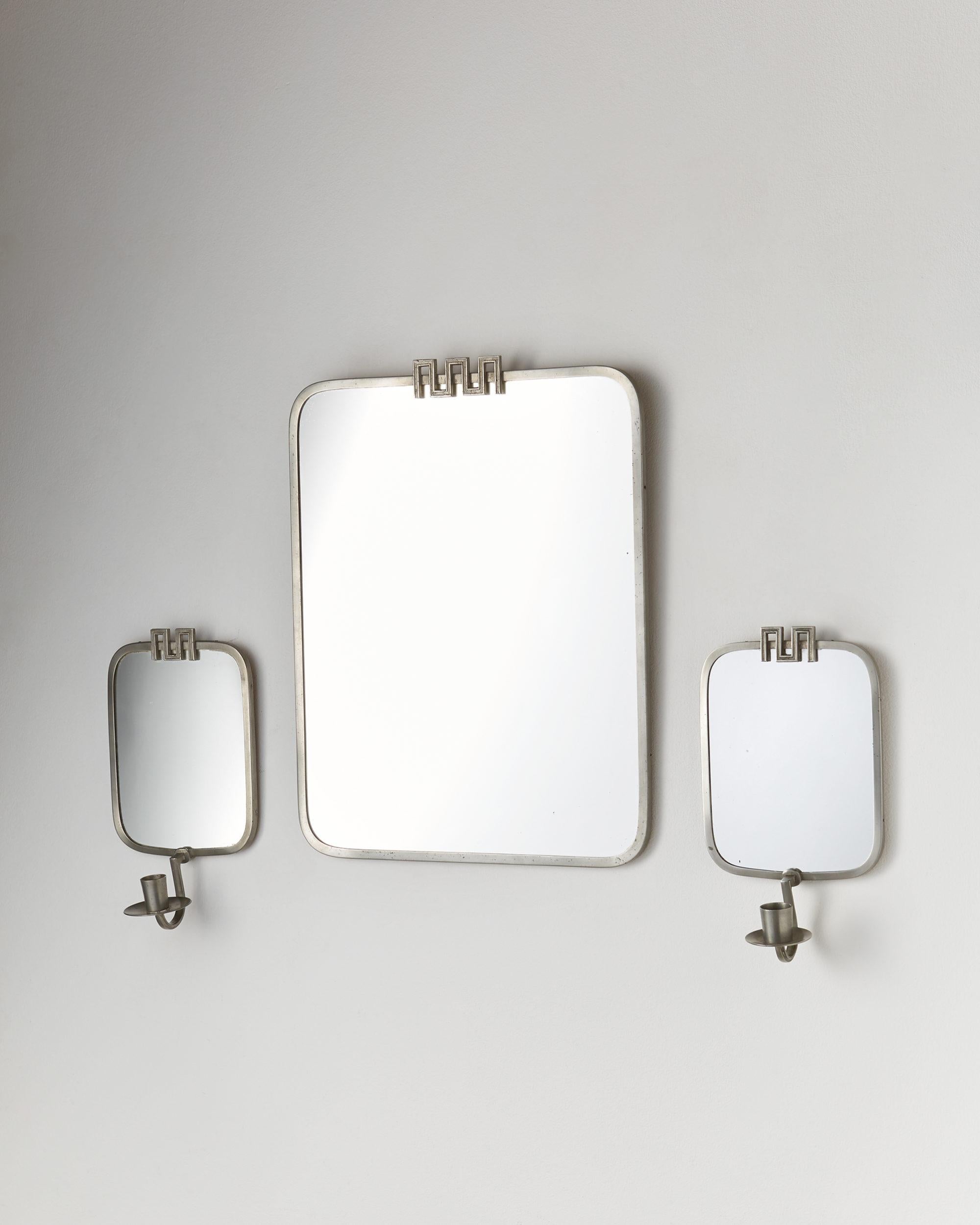 Mirror and two candleholders designed by Nils Fougstedt for FAK,
Sweden, 1933.

Pewter and mirrored glass.

Measures: Mirror
H 43 cm/ 17