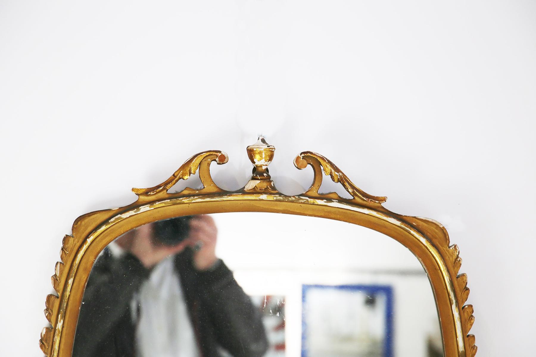 Beautiful mirror attributed to Paolo Buffa from the 1950s.
The edge of the mirror was made with a large carved woodwork in the shape of foliage, golden color.