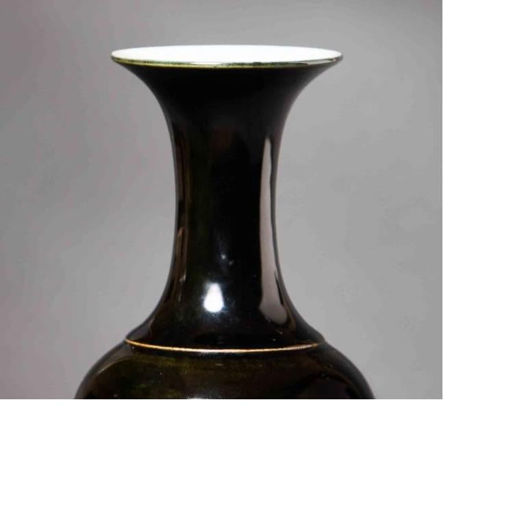 Material: Ceramic 
Origin: China
Age: Guan Tung period, circa 1900
Size: 10 inches in height 

As designers we plant these vases with orchids or silk flowers and display on coffee tables or consoles. The color of this vase makes it appear