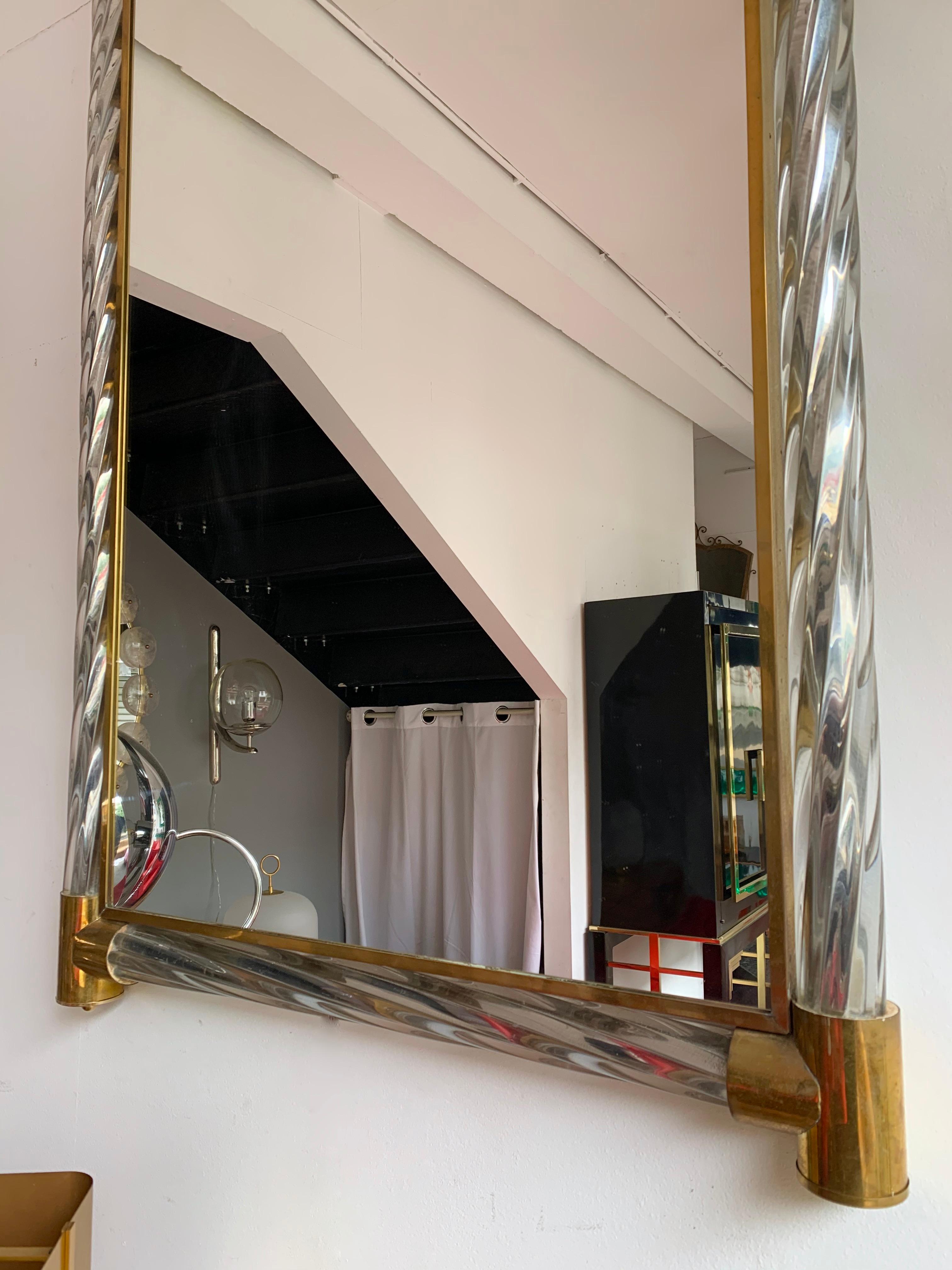 Brass wall mirror with massive twisted Murano glass with silver leaf in the glass attributed to Barovier & Toso for this high quality.