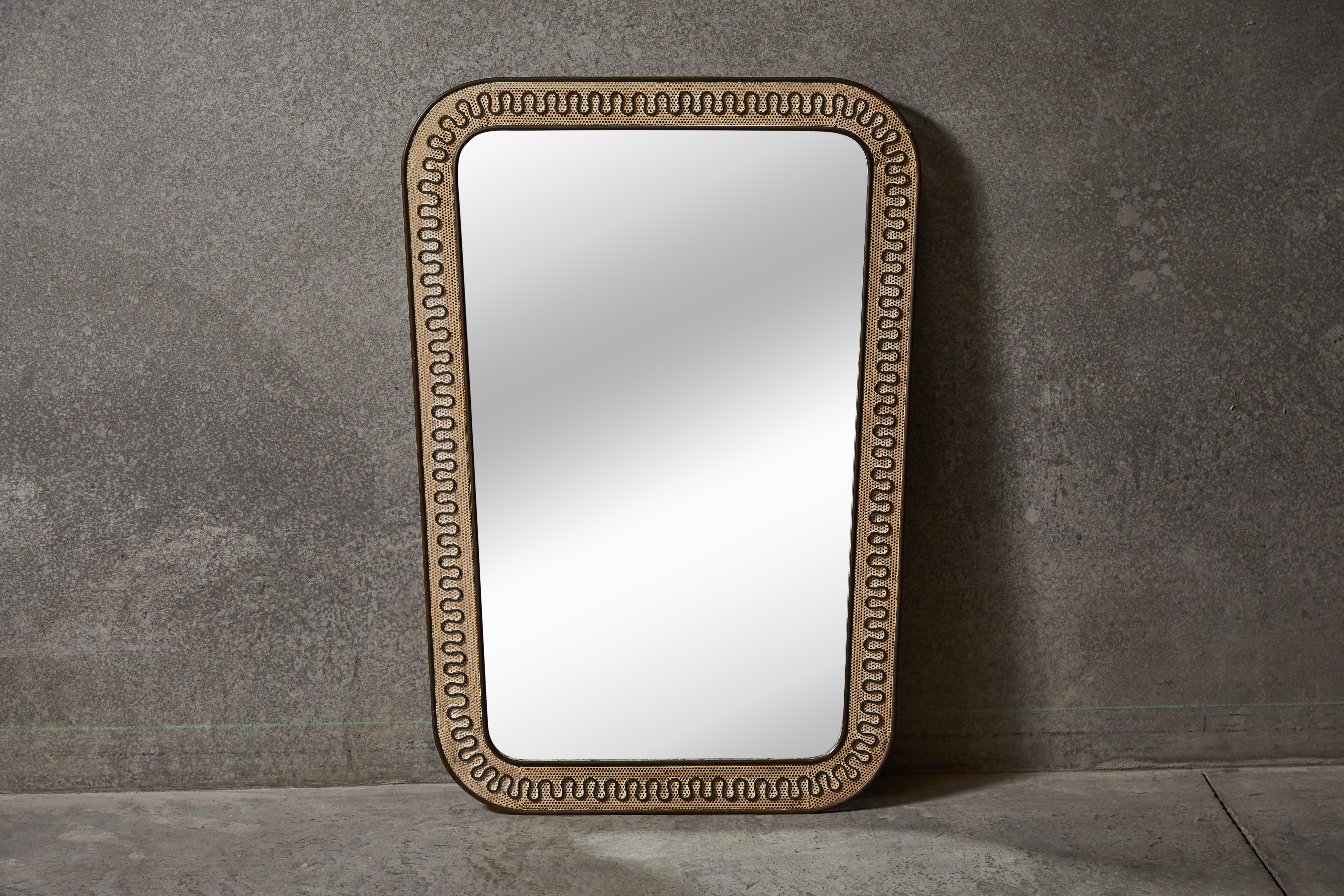 Italian brass and perforated metal mirror by Carlo Erba. Made in Italy, circa 1950s.