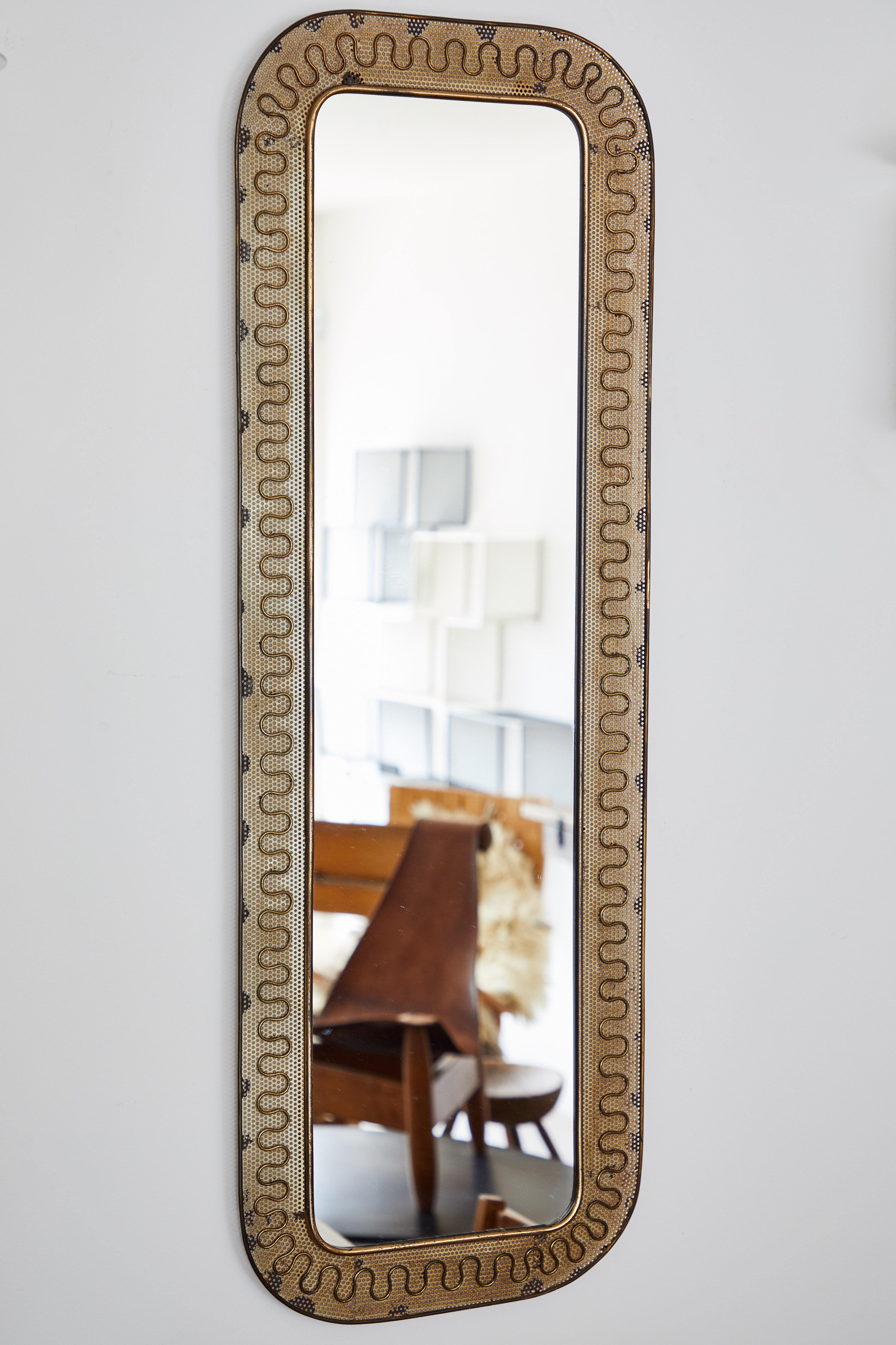 Italian brass and perforated metal mirror by Carlo Erba. Made in Italy, circa 1950s.