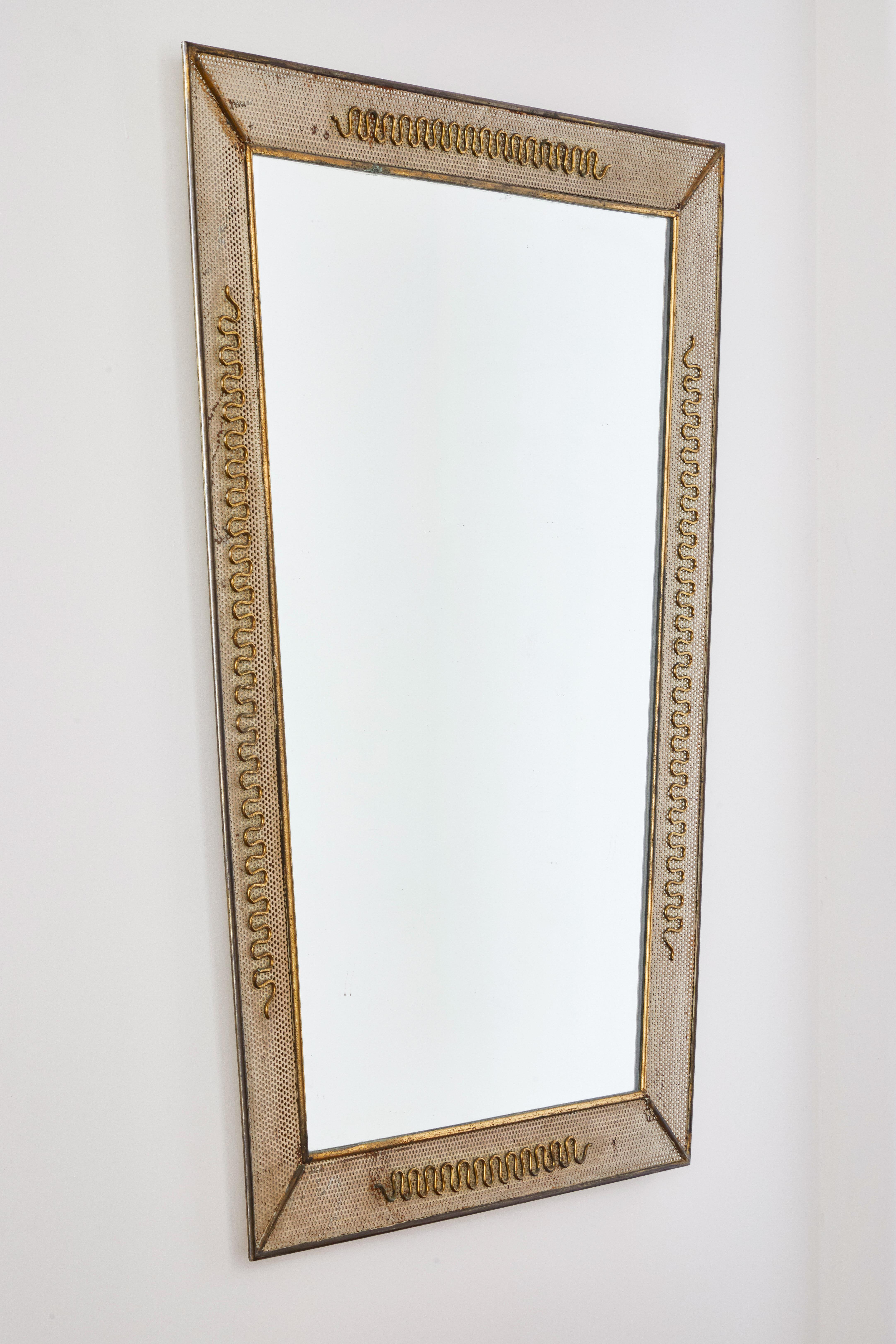 Italian brass and perforated metal mirror by Carlo Erba. Made in Italy, circa 1950s.