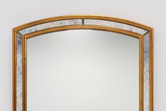 Mirror by Deknudt with marbled fume glass side panels in gilded wooden frame