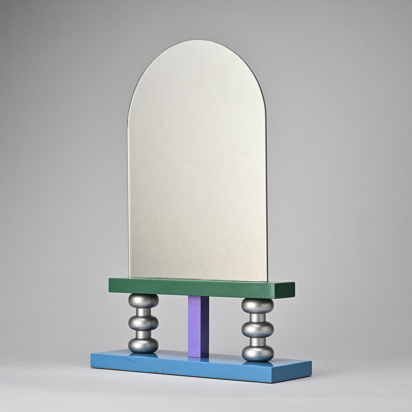 Nathalie Du Pasquier is a prolific artist and designer, renowned for her pivotal role as a member of the Memphis group, whose groundbreaking creations defined the design landscape of the 1980s.

This multicolored lacquered wood table mirror, dating