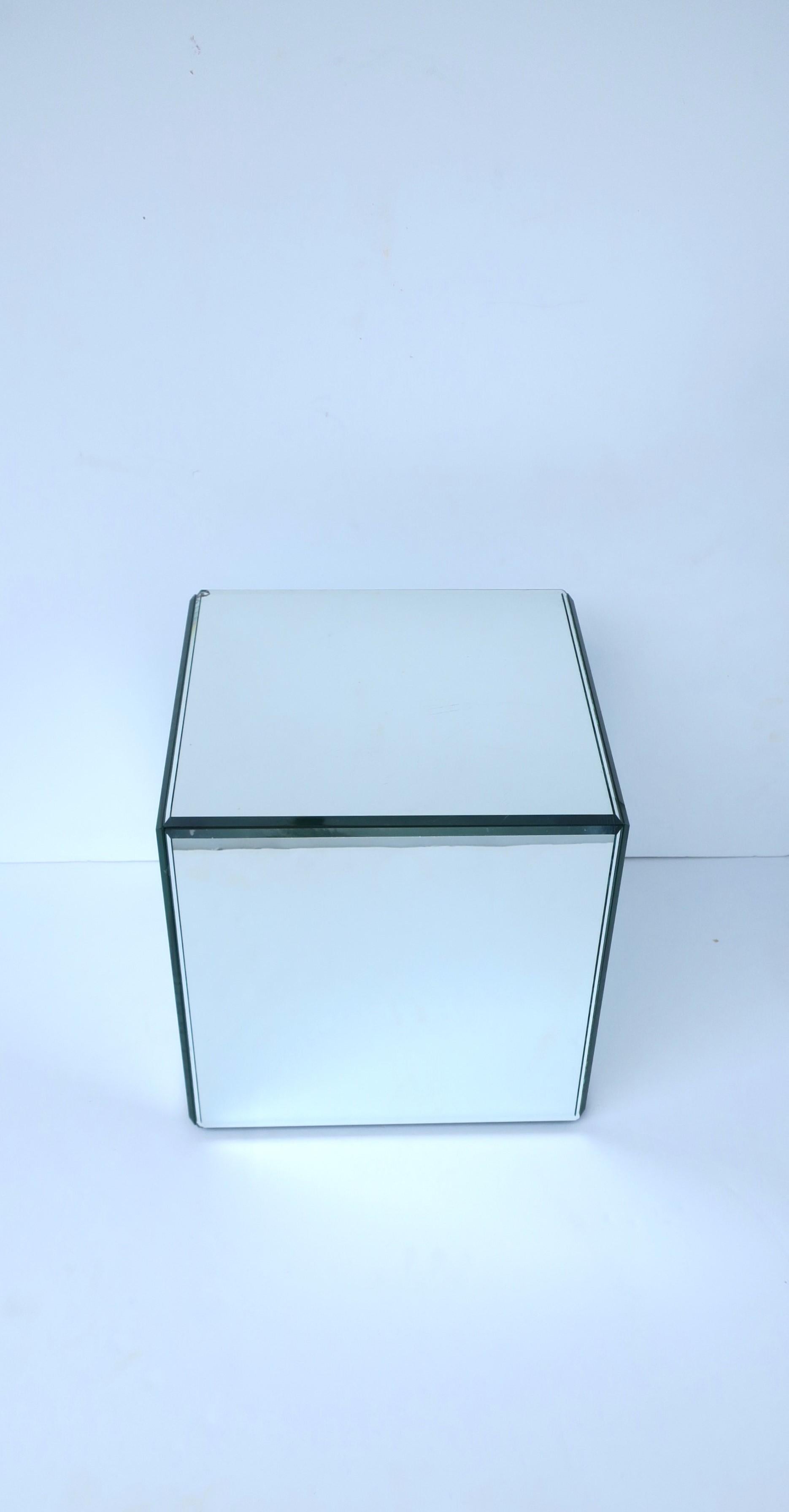 A mirrored cube pedestal table, in the Modern style, circa 1970s. A substantial and well-made piece of the '70s modern period. Use as a small end table, side table, drinks table, to display sculpture, books, as a plant stand, etc. A great piece in a