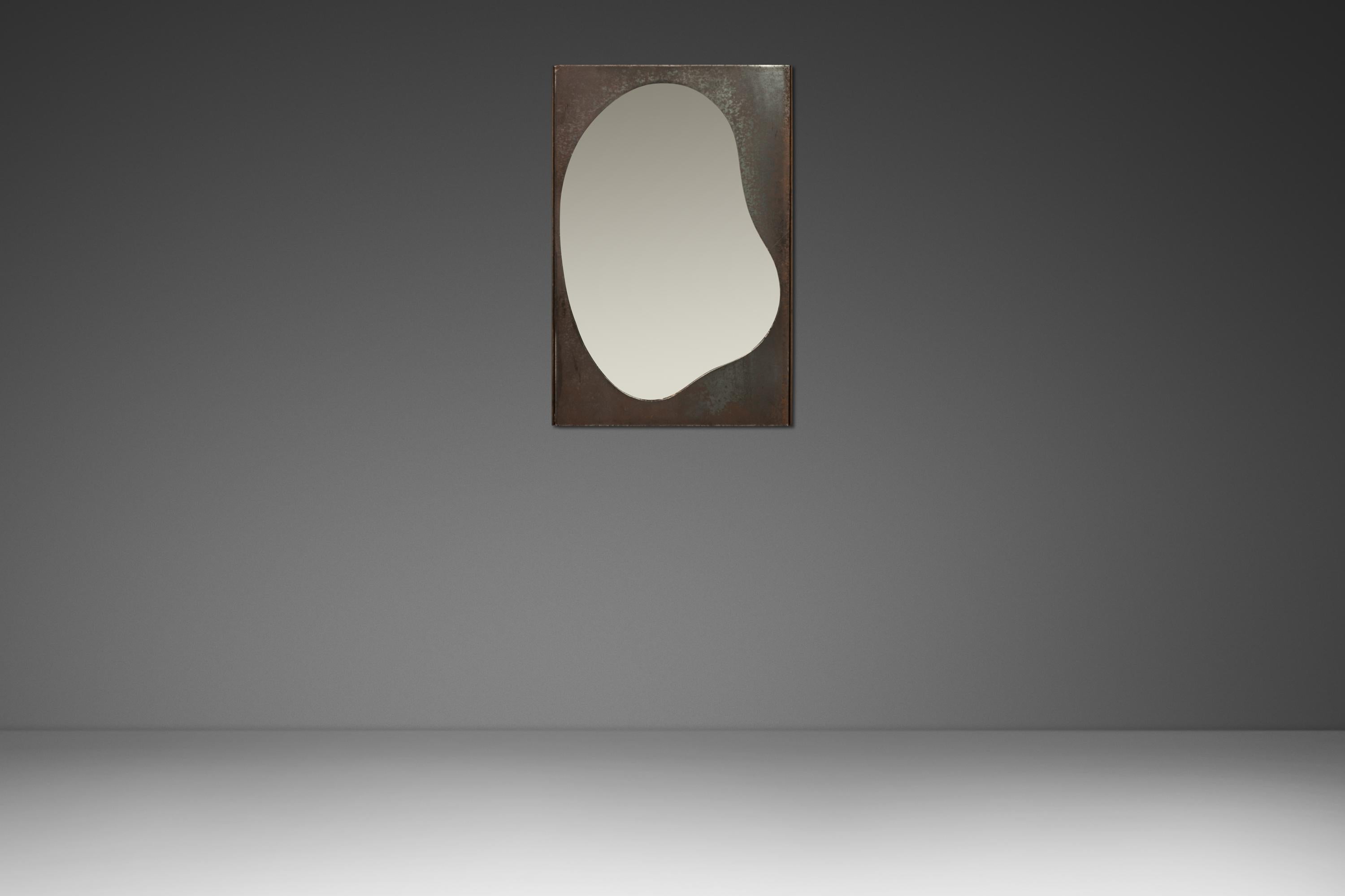 Introducing a one-of-a-kind wall mirror sculpted and cut by Mark Leblanc for Leblanc Studios. Cut from a solid piece of architectural steel this wall mirror sports a perfect patina that is ideal for Brutalist or Industrial interiors. The playful,
