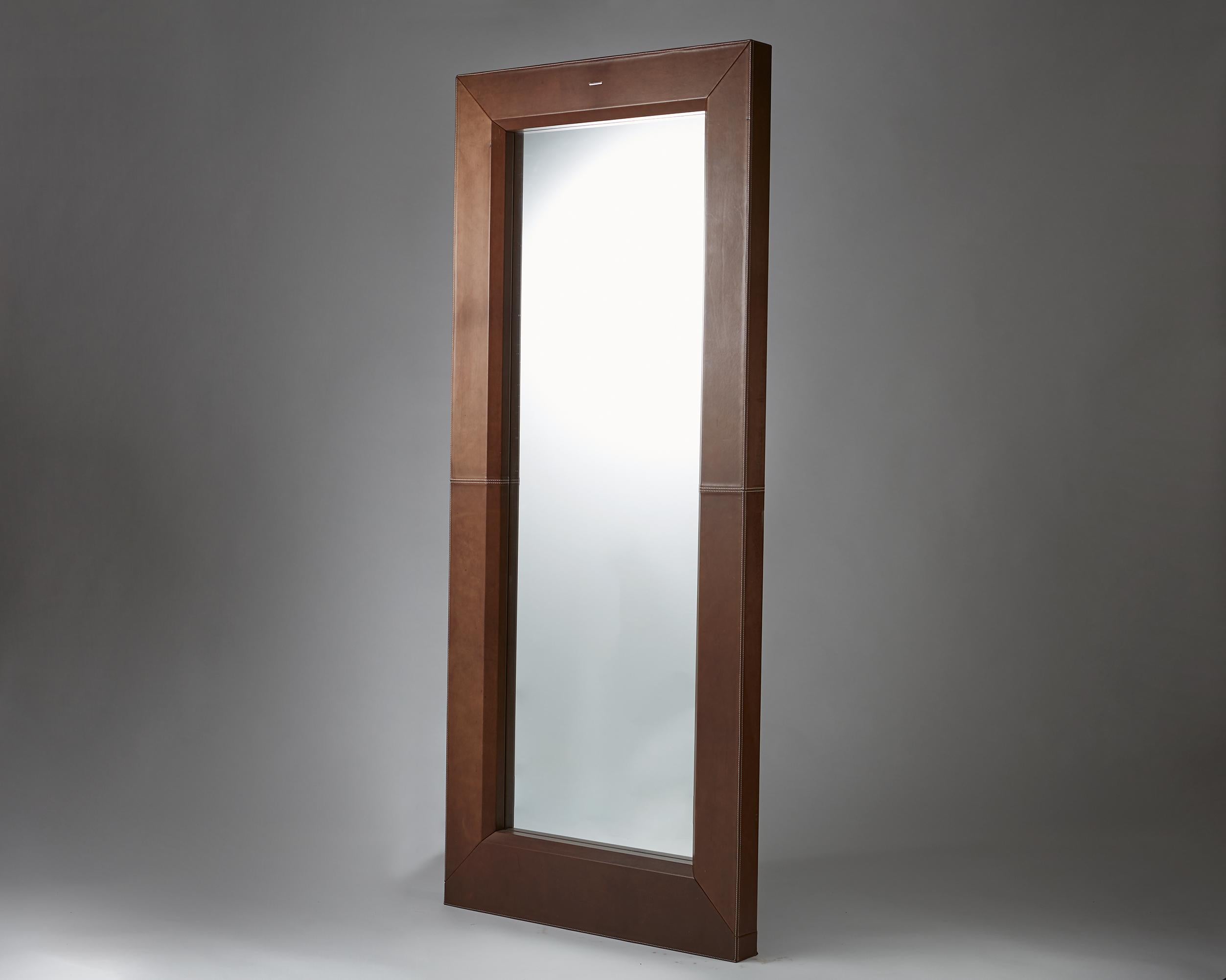 Mirror designed by Enrico Tonucci for Triangolo,
Italy. 1980s. 

Wood, leather and mirrored glass.

Measurements: 
H: 210 cm/ 6' 11''
W: 90 cm/ 3'