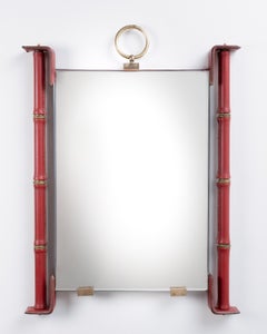 Mirror fully covered in red leather with saddle stitching by Jacques Adnet