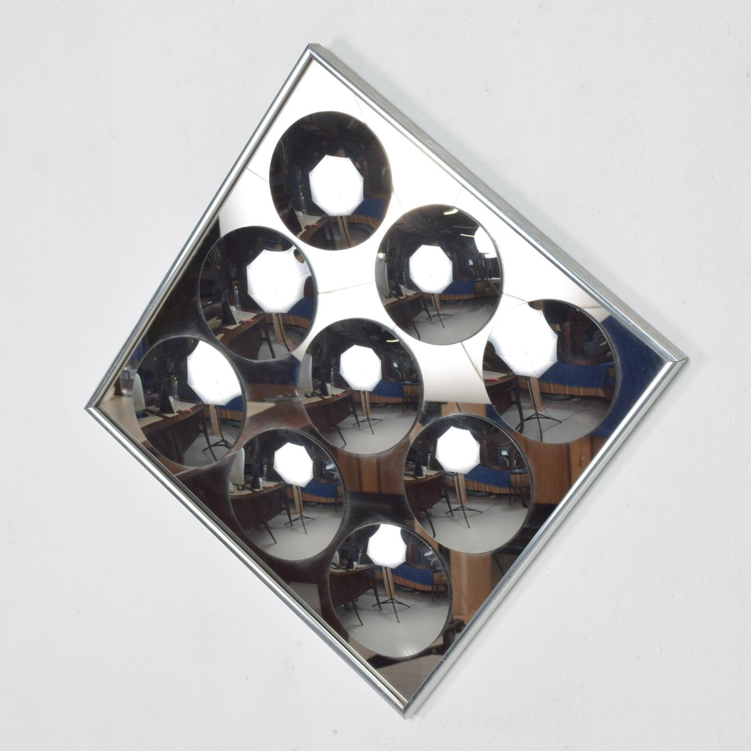 We are pleased to offer for your consideration a mirror graphics, by Bienenfeld Industries INC, Hal Bienenfeld. Mid-Century Modern Op art mirror. Beautiful square shape with original aluminum frame and nine concave mirrors. The current configuration