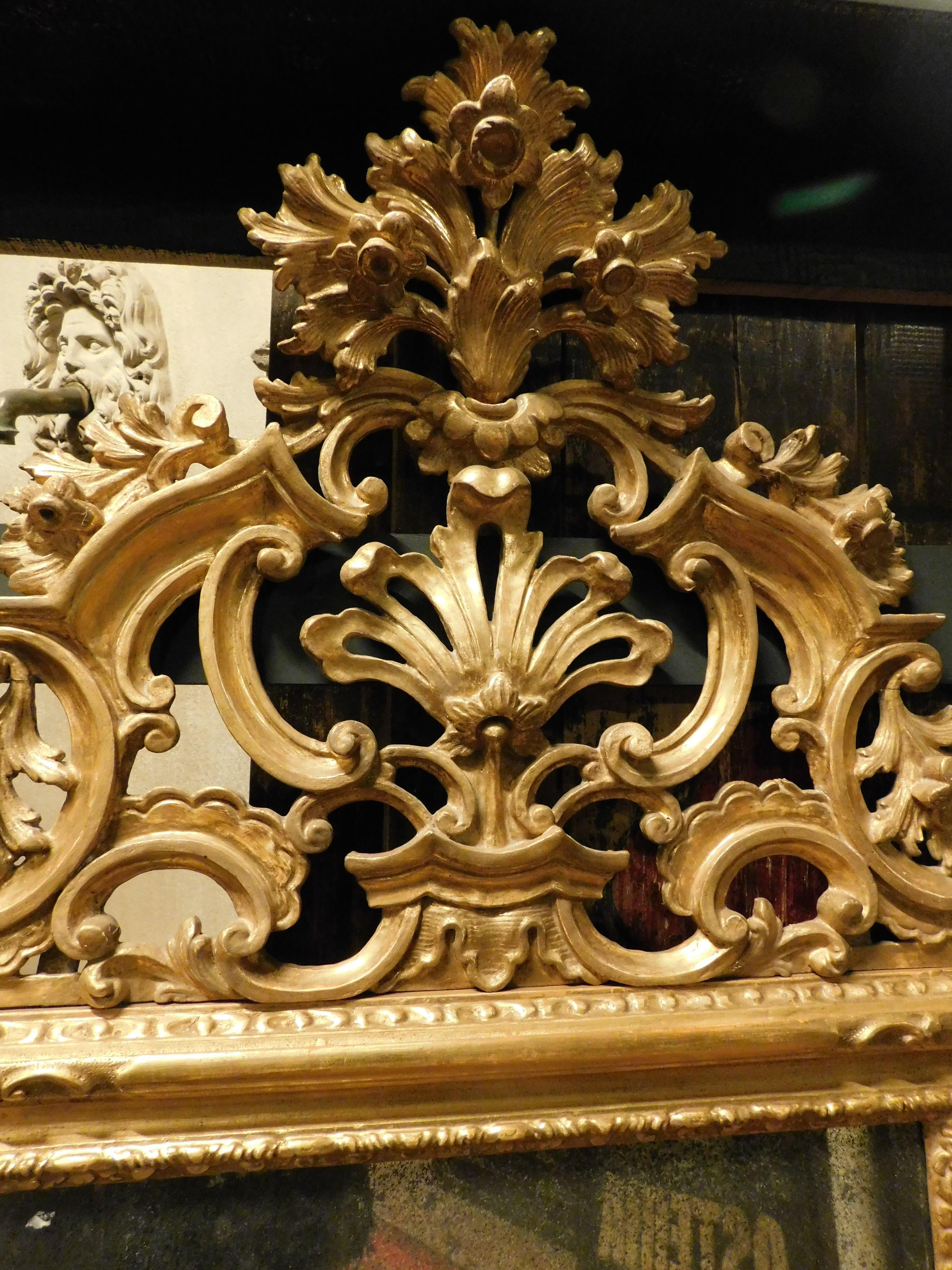 Hand-Carved Mirror in gilded wood, richly frieze perforated volutes, floral and leafy, '800 For Sale
