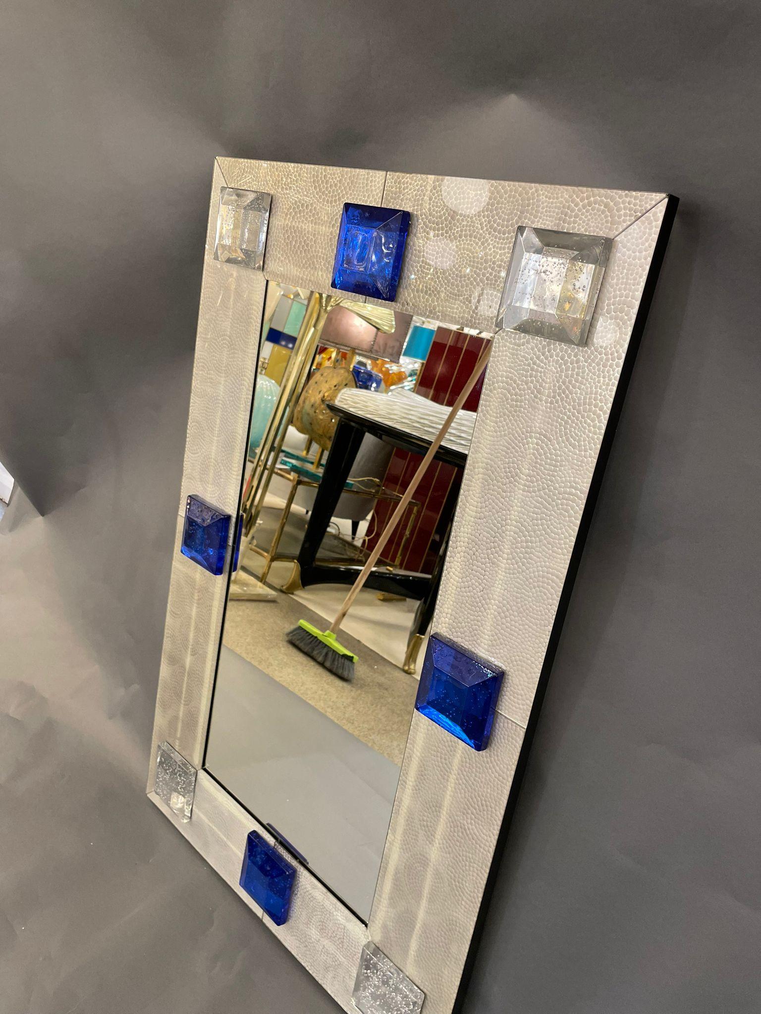 A shiny grey hand-hammered Venetian glass mirror adorned with thick squared Murano glass in silver and cobalt blue. Italy, 1980s.