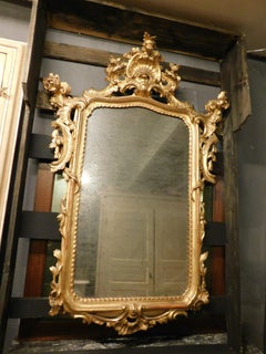 Mirror in lacquered and gilded wood, rich cymatium carved with shell, Italy